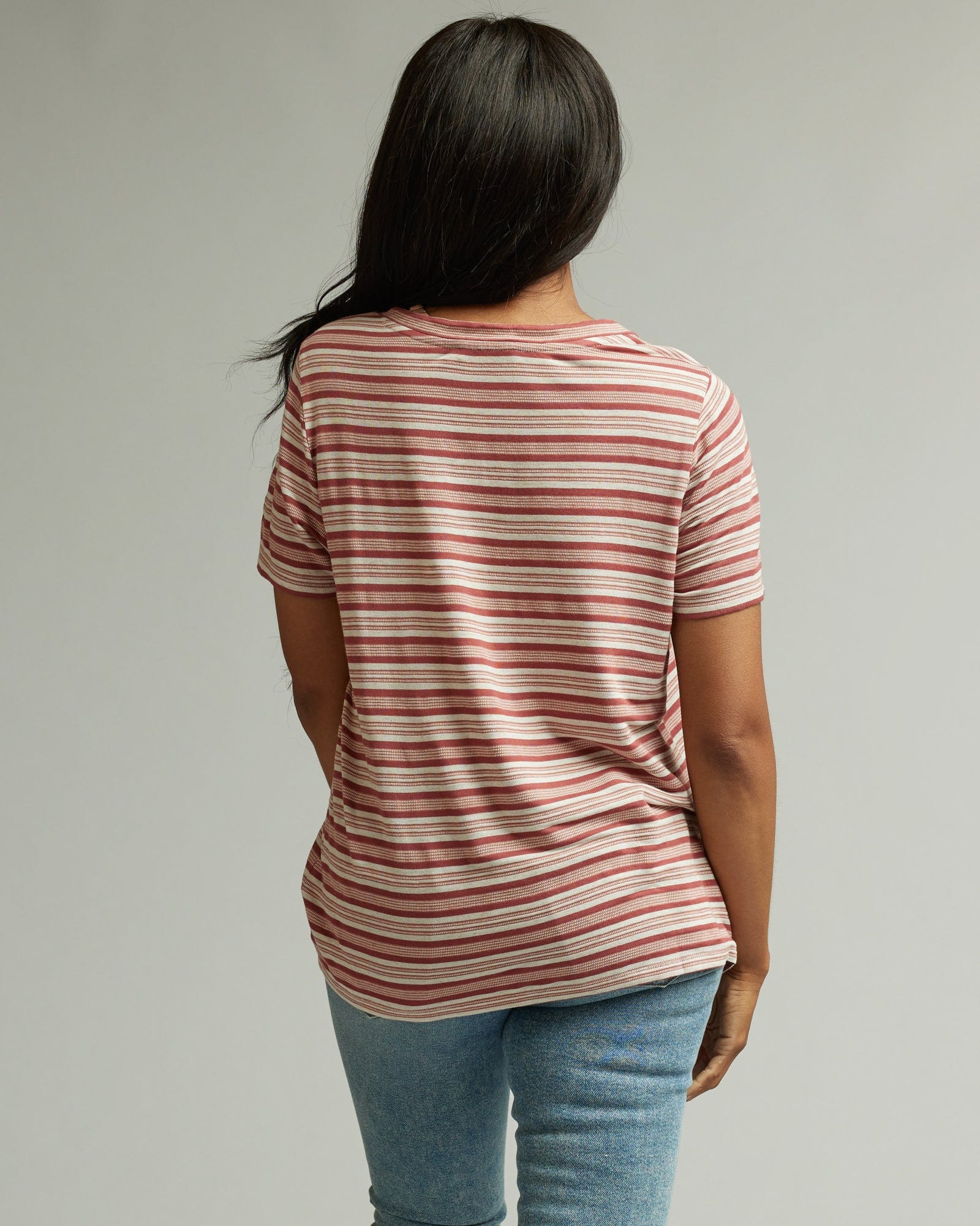 Woman in a short sleeve, v-neck, pink striped t-shirt