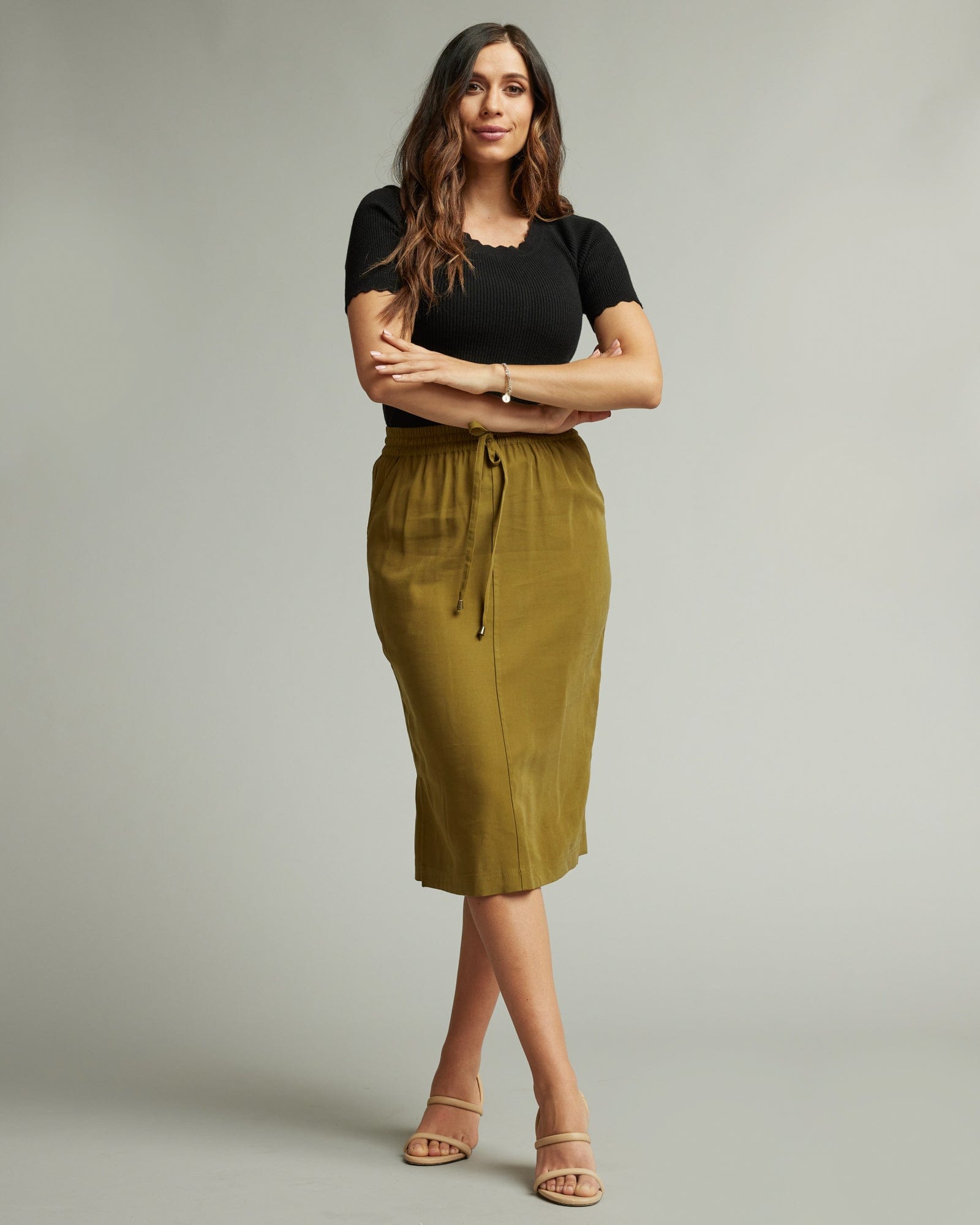 Woman in an olive knee-length skirt