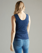Woman in sleeveless, fitted, basic tank top