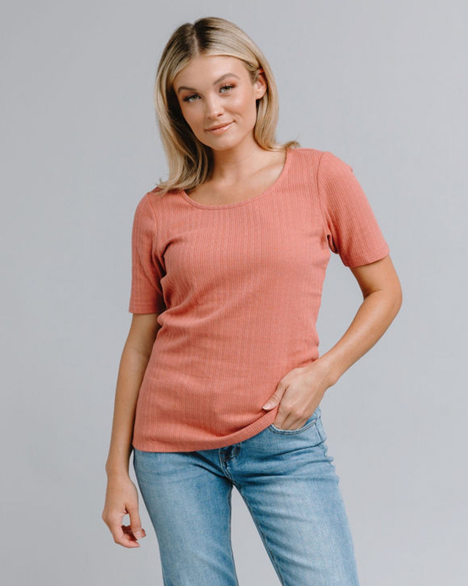 Woman in a half sleeved, ribbed t-shirt