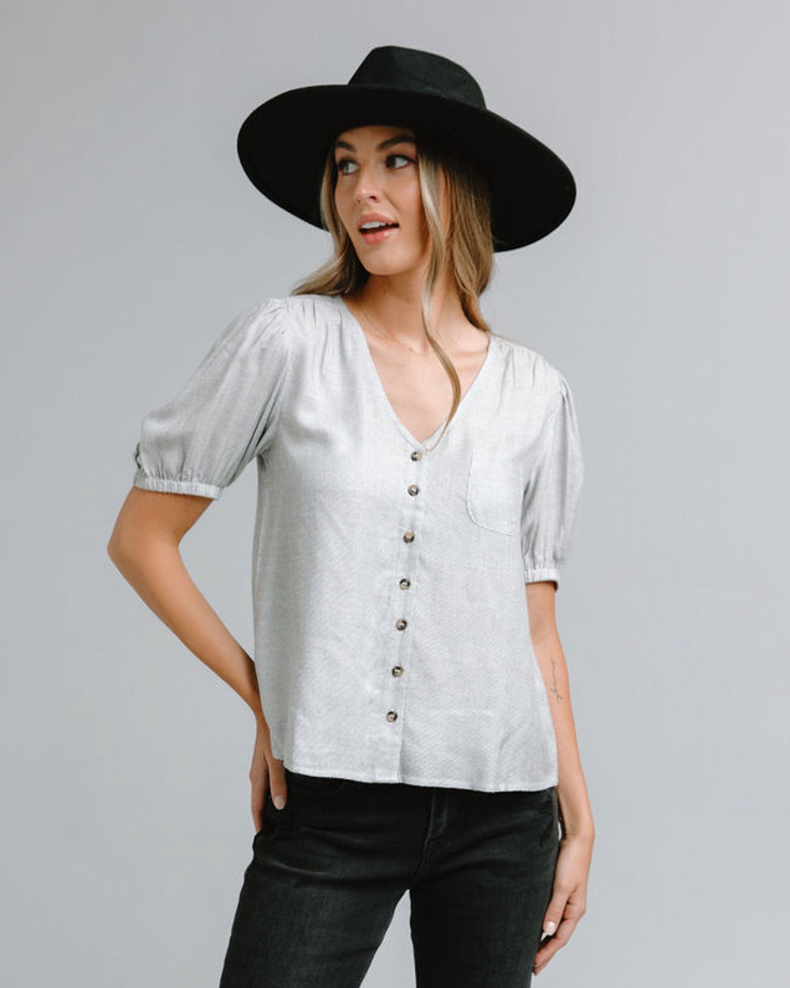 Woman in a short sleeve, v-neck blouse with front buttons