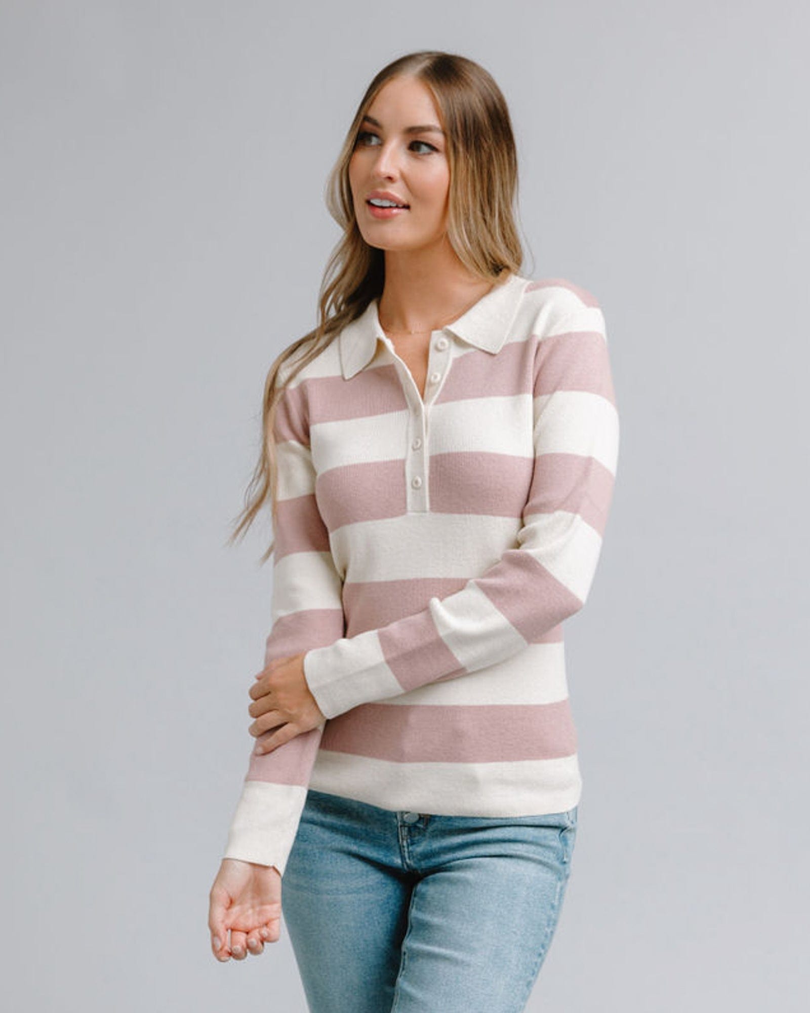 Woman in a striped long sleeve, collared sweater