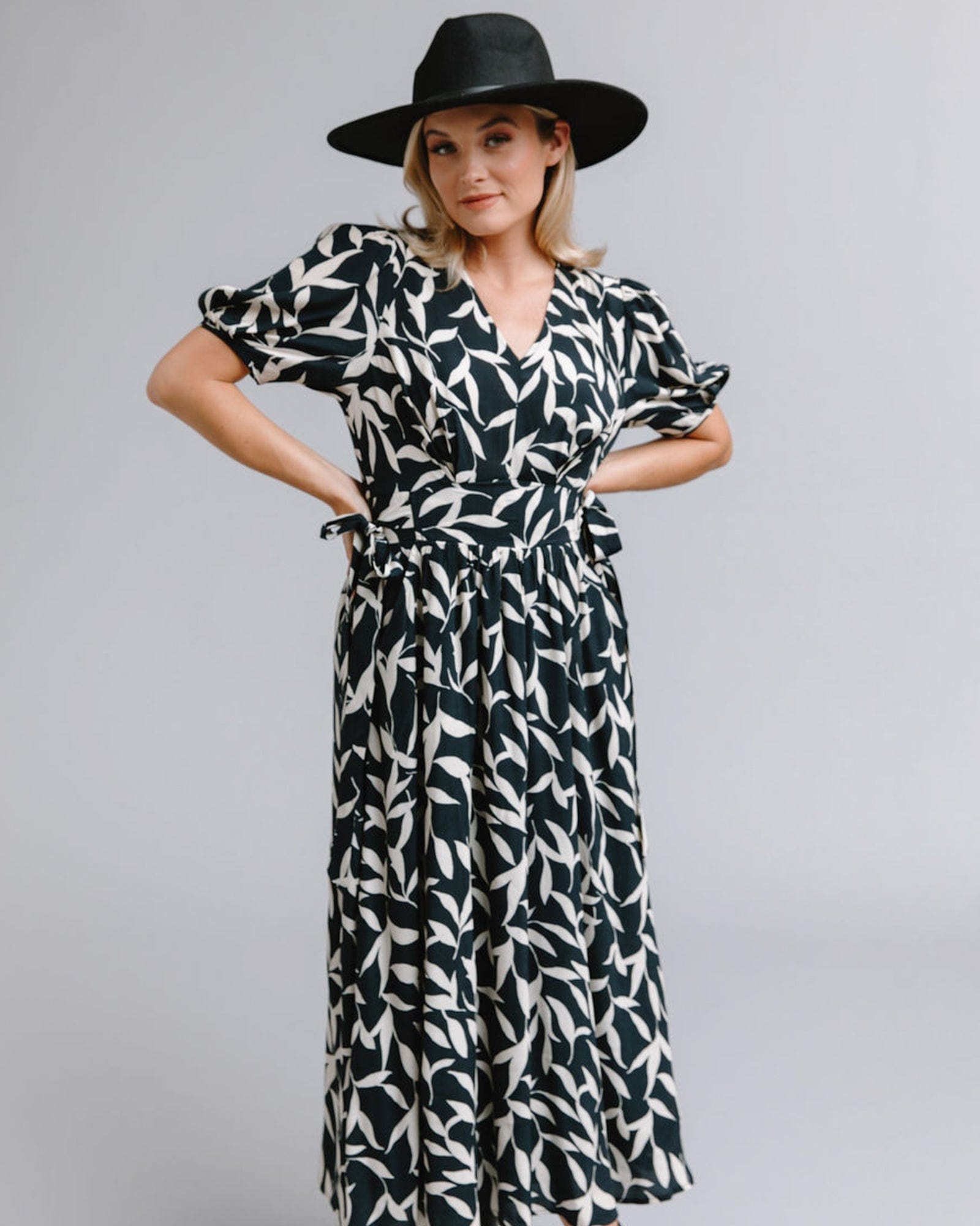 Woman in a short sleeve, midi-length, black and white print dress