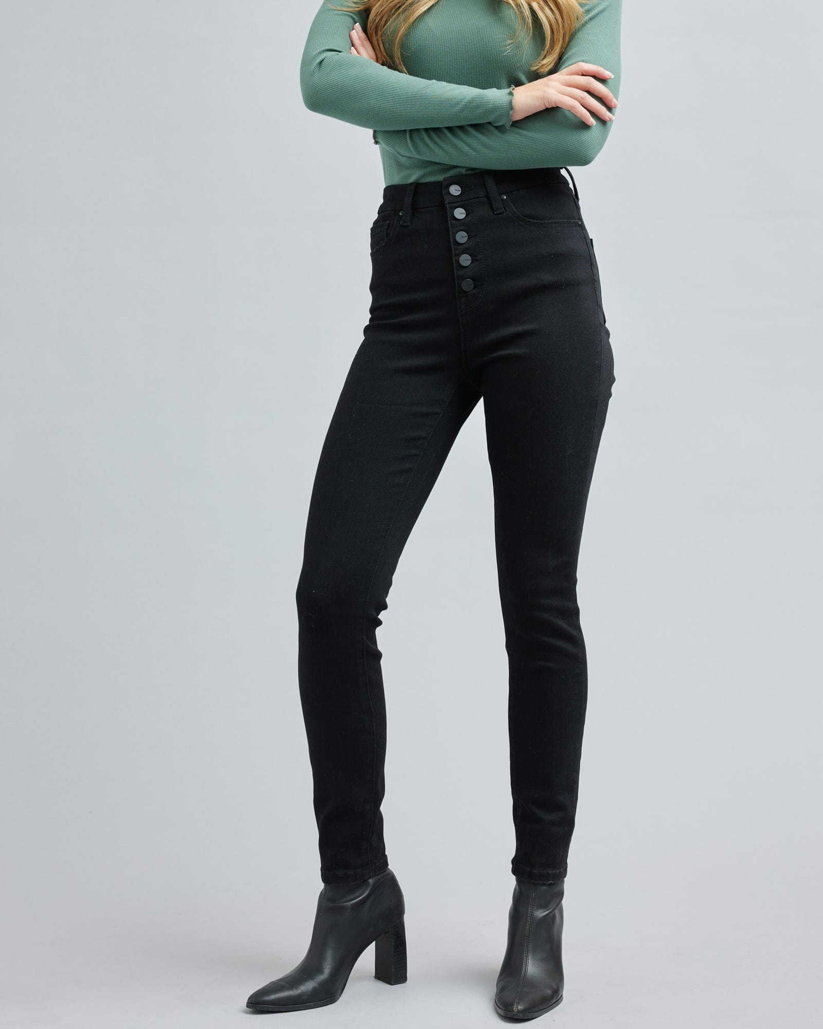 Woman in a high-waisted, black, denim pant