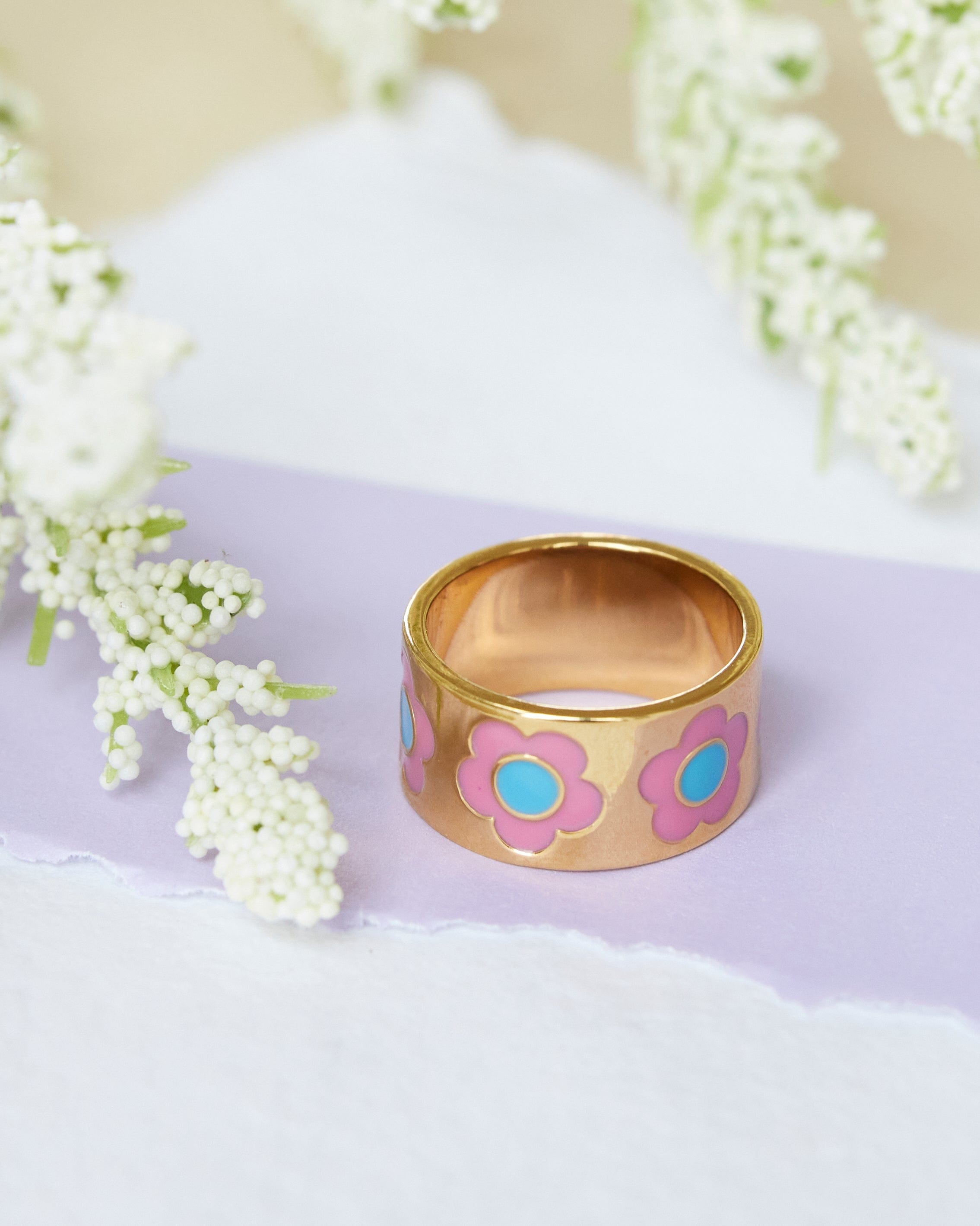 Gold ring with purple flowers
