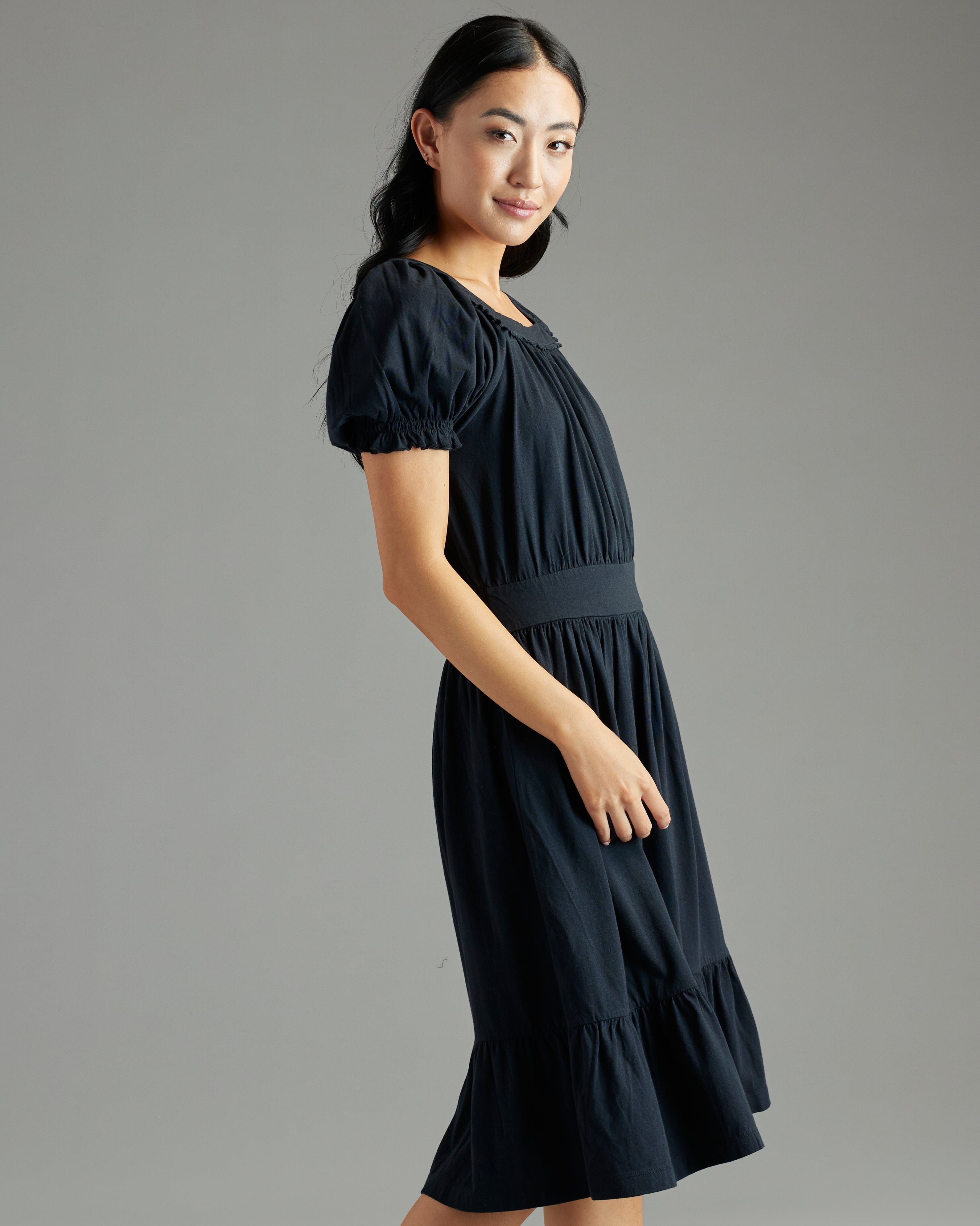 Womani n a short sleeve, square neckline, knee-length, black dress