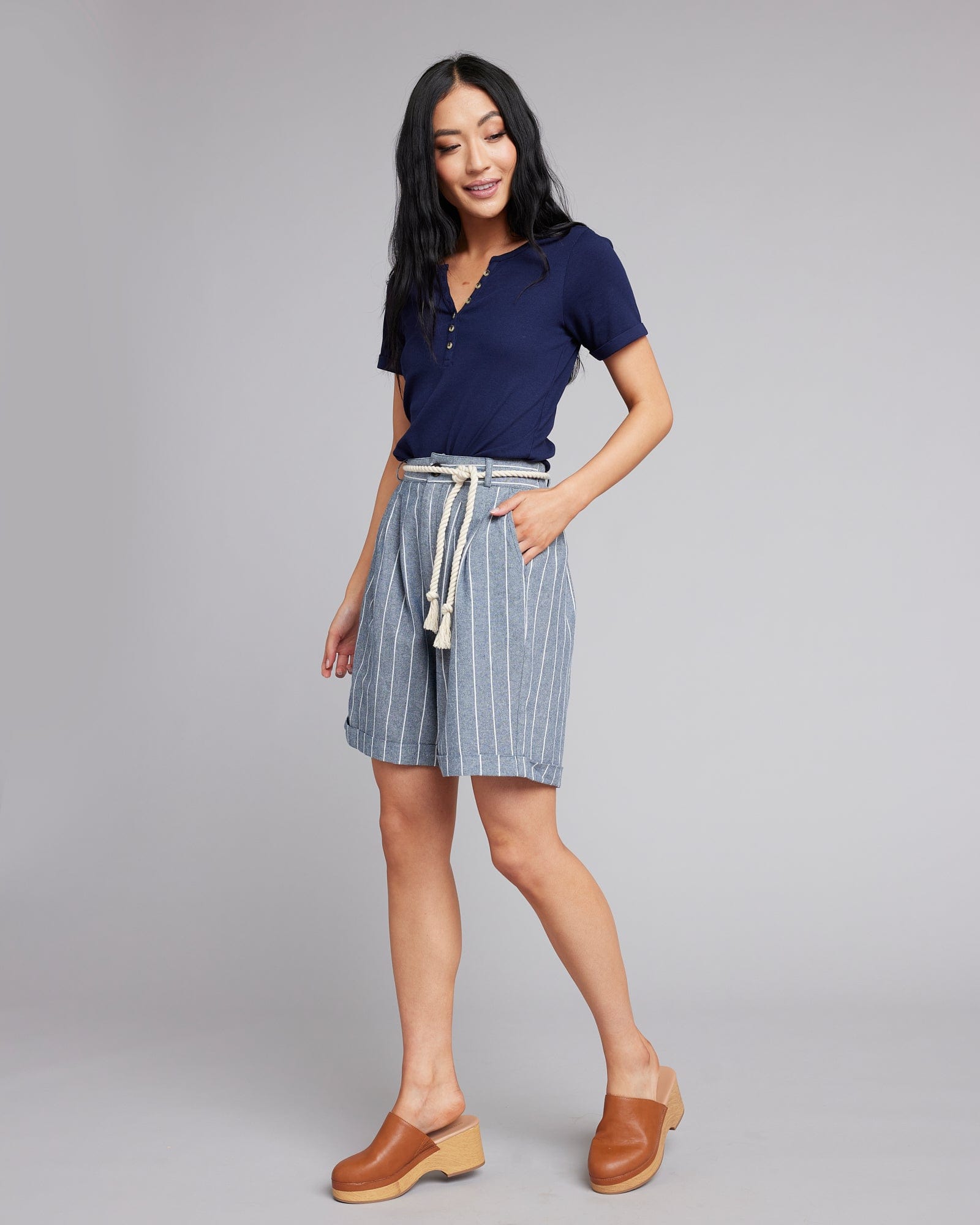 Woman in blue and white vertical striped shorts