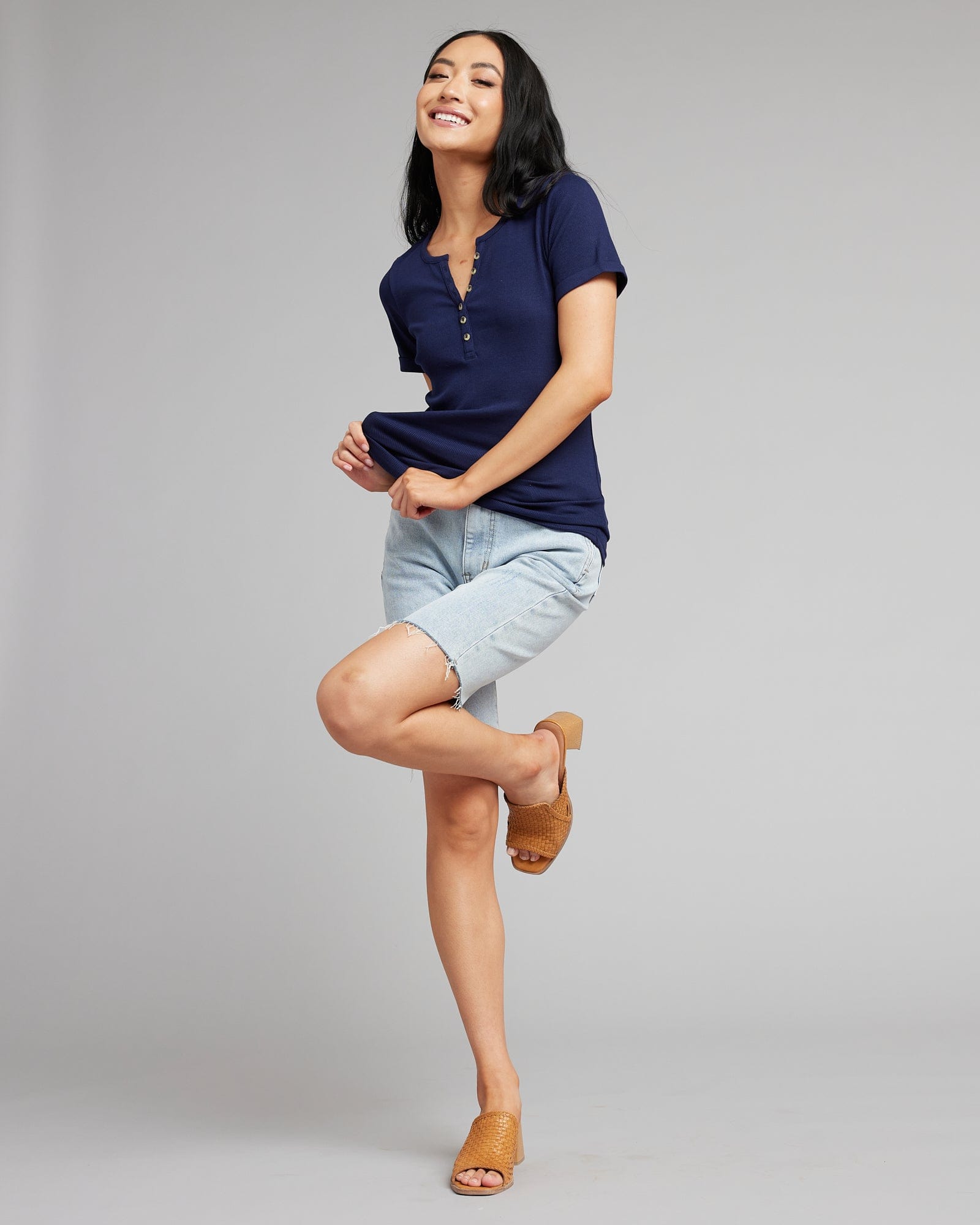 Woman in a short sleeved, henley top