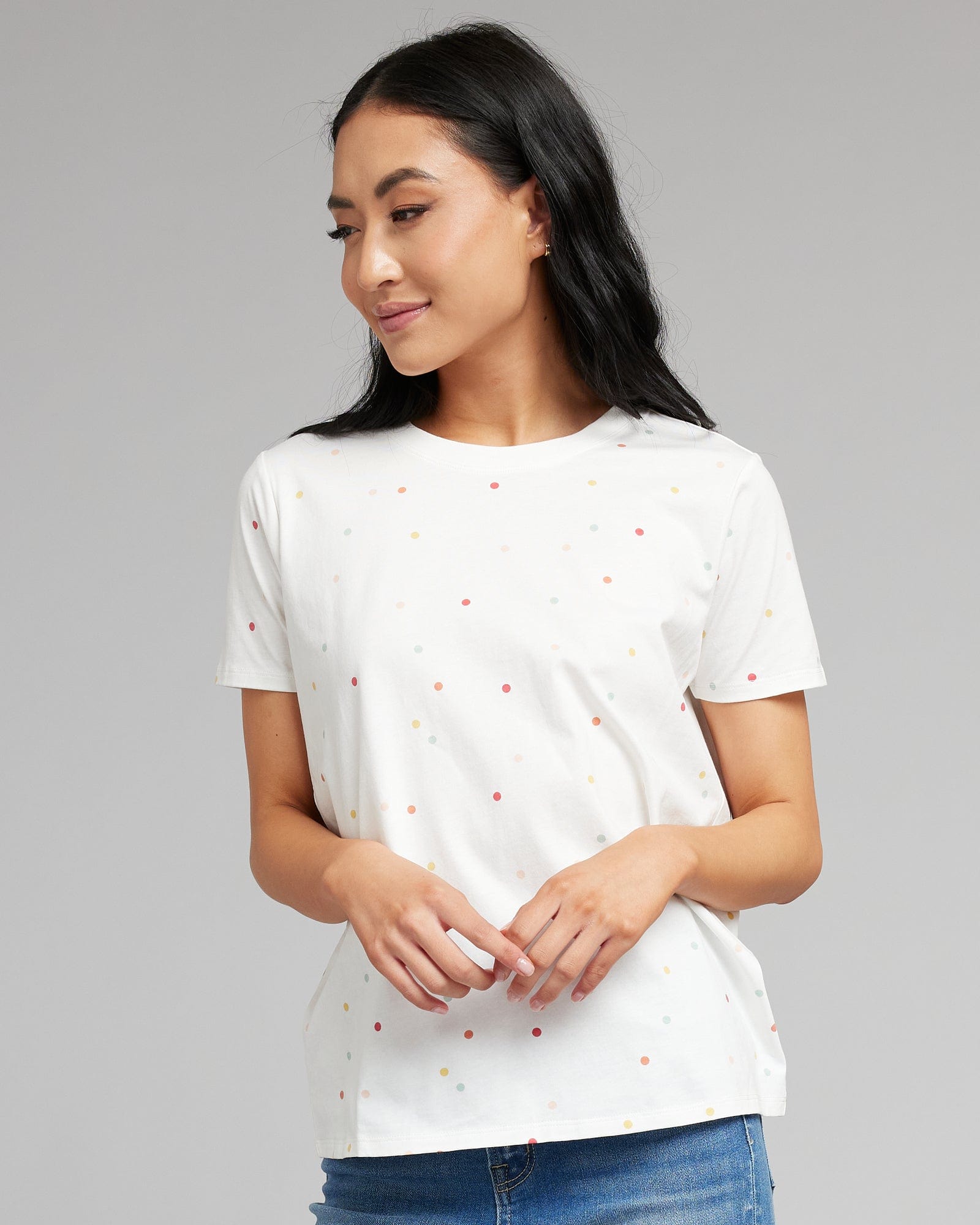 Woman in a white short sleeved t-shirt with polka dots