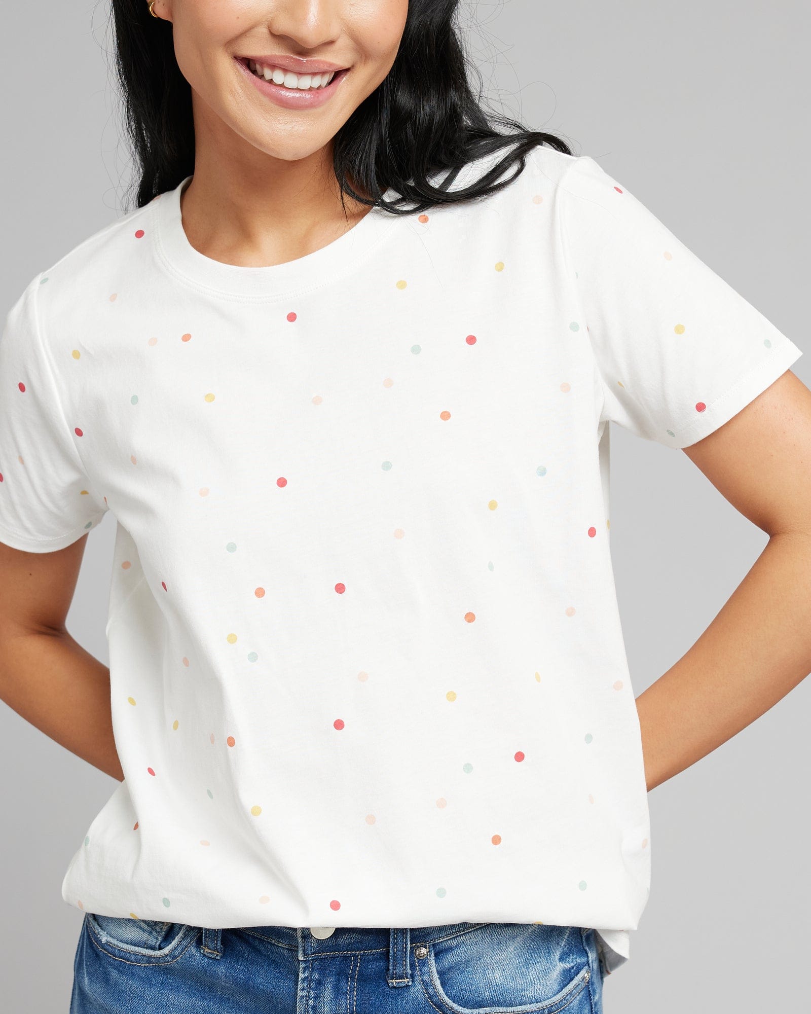 Woman in a white short sleeved t-shirt with polka dots