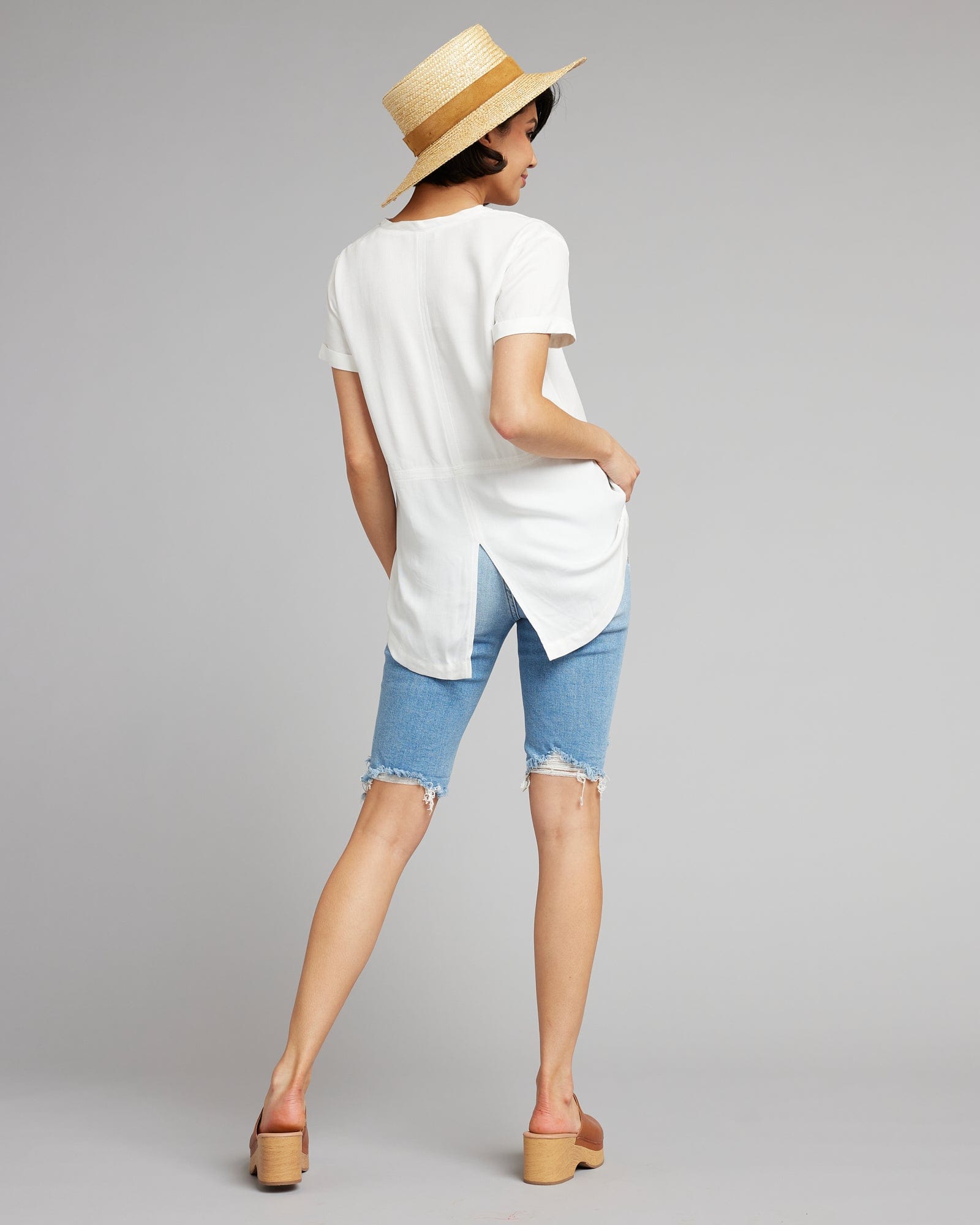 Woman in a white, short sleeve, v-neck basic tee