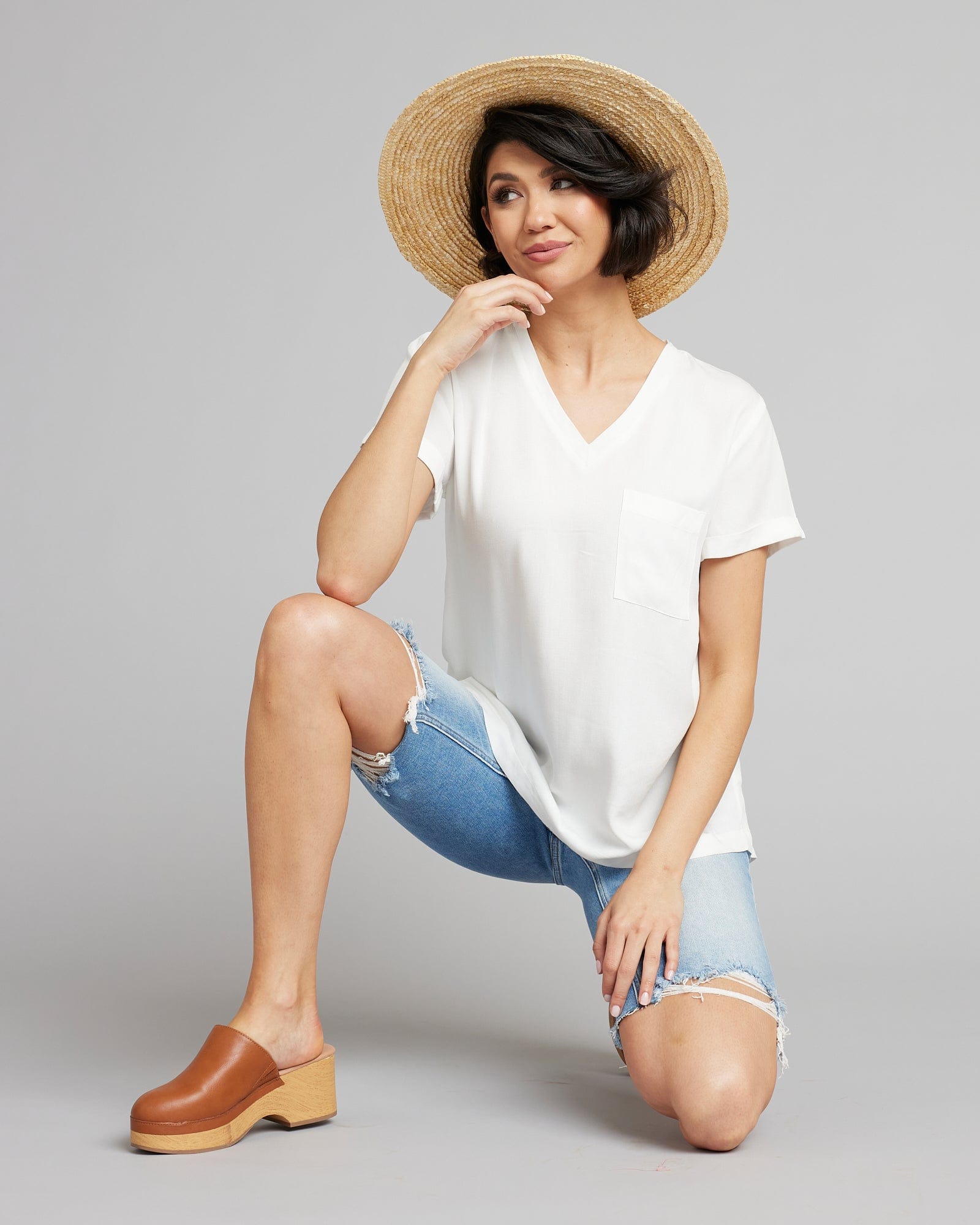 Woman in a white, short sleeve, v-neck basic tee