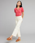 Woman in white high rise cropped denim pants.