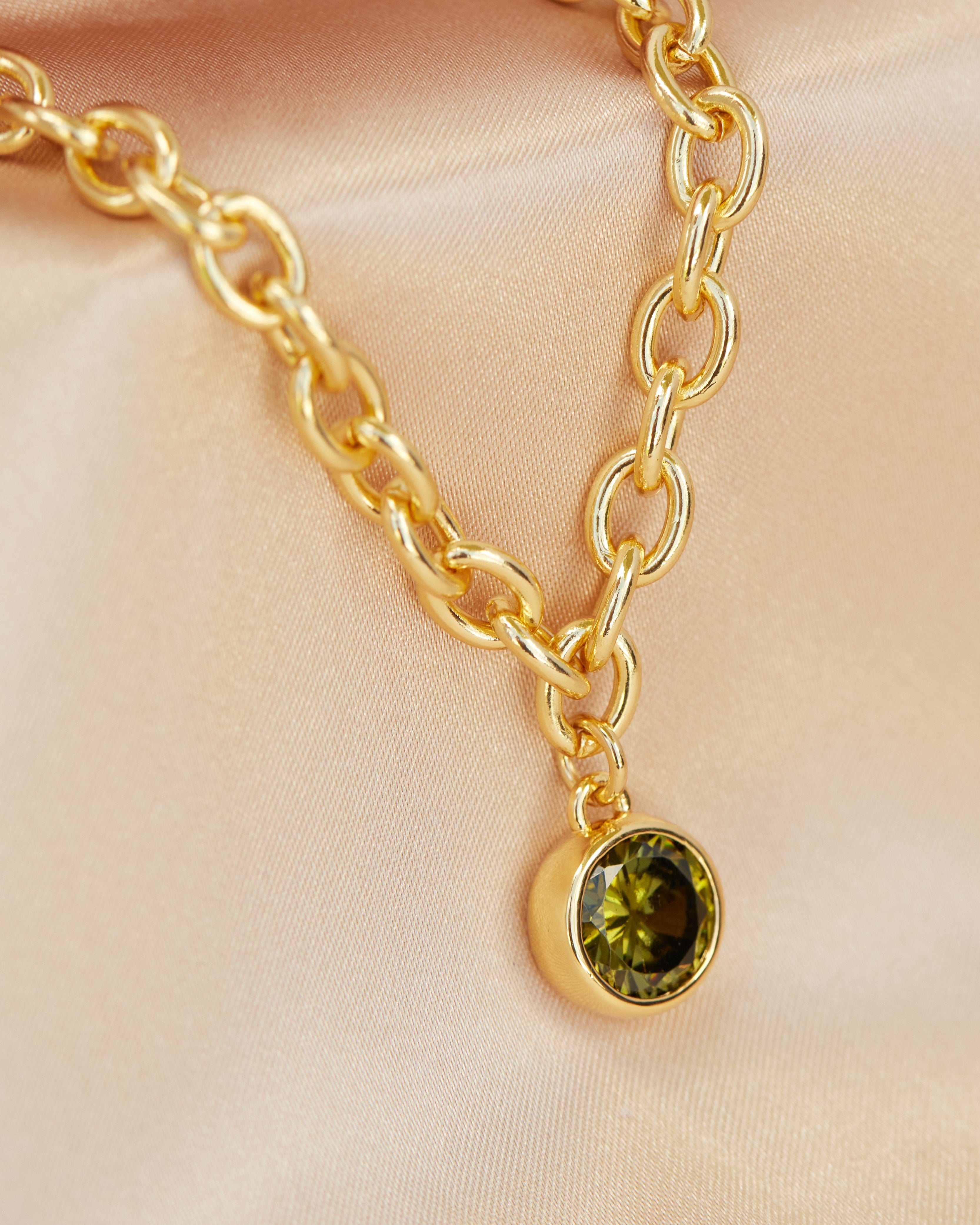 Gold necklace with green jewel charm