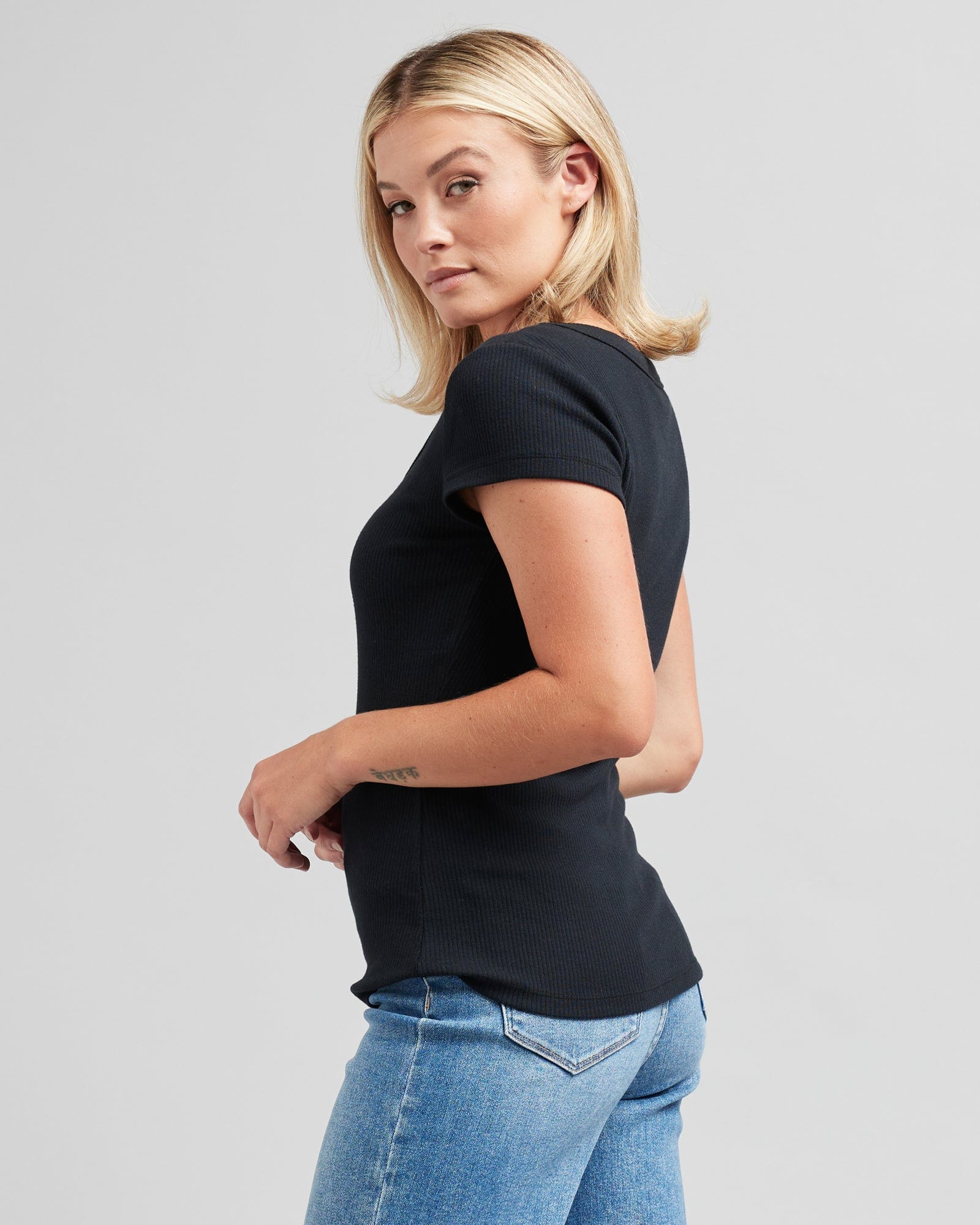 Woman in a short sleeve, black, fitted tee