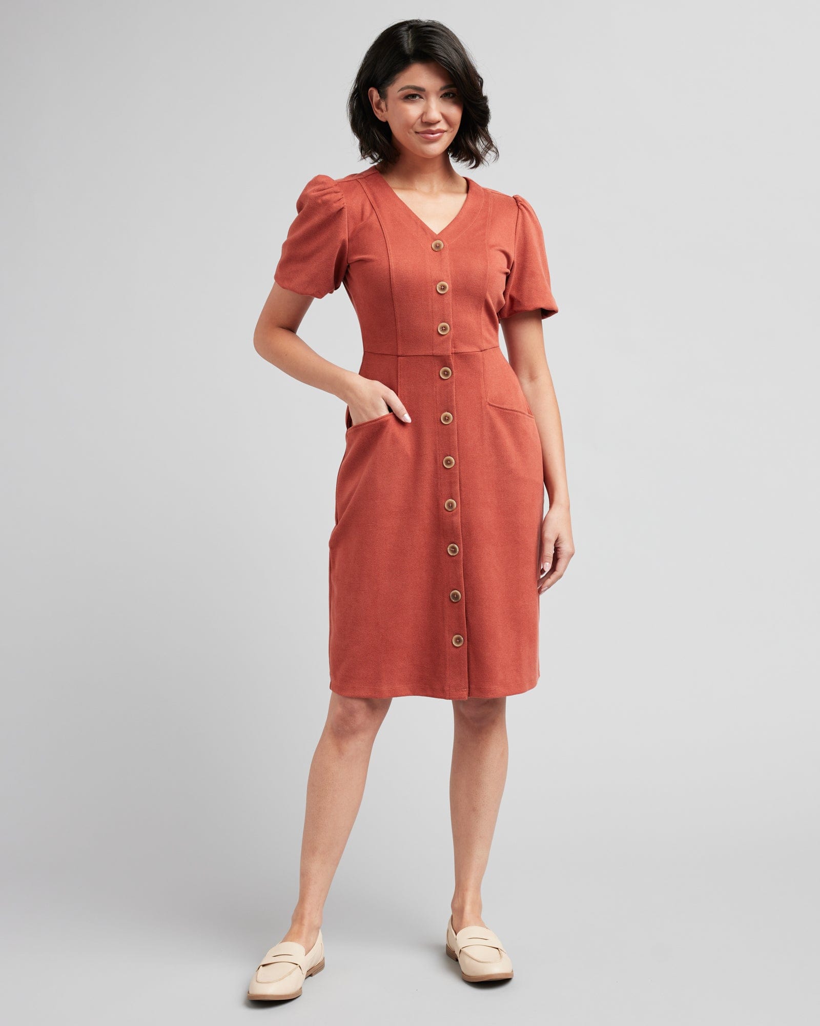 Woman in a short sleeve, v-neck, button-down, orange dress