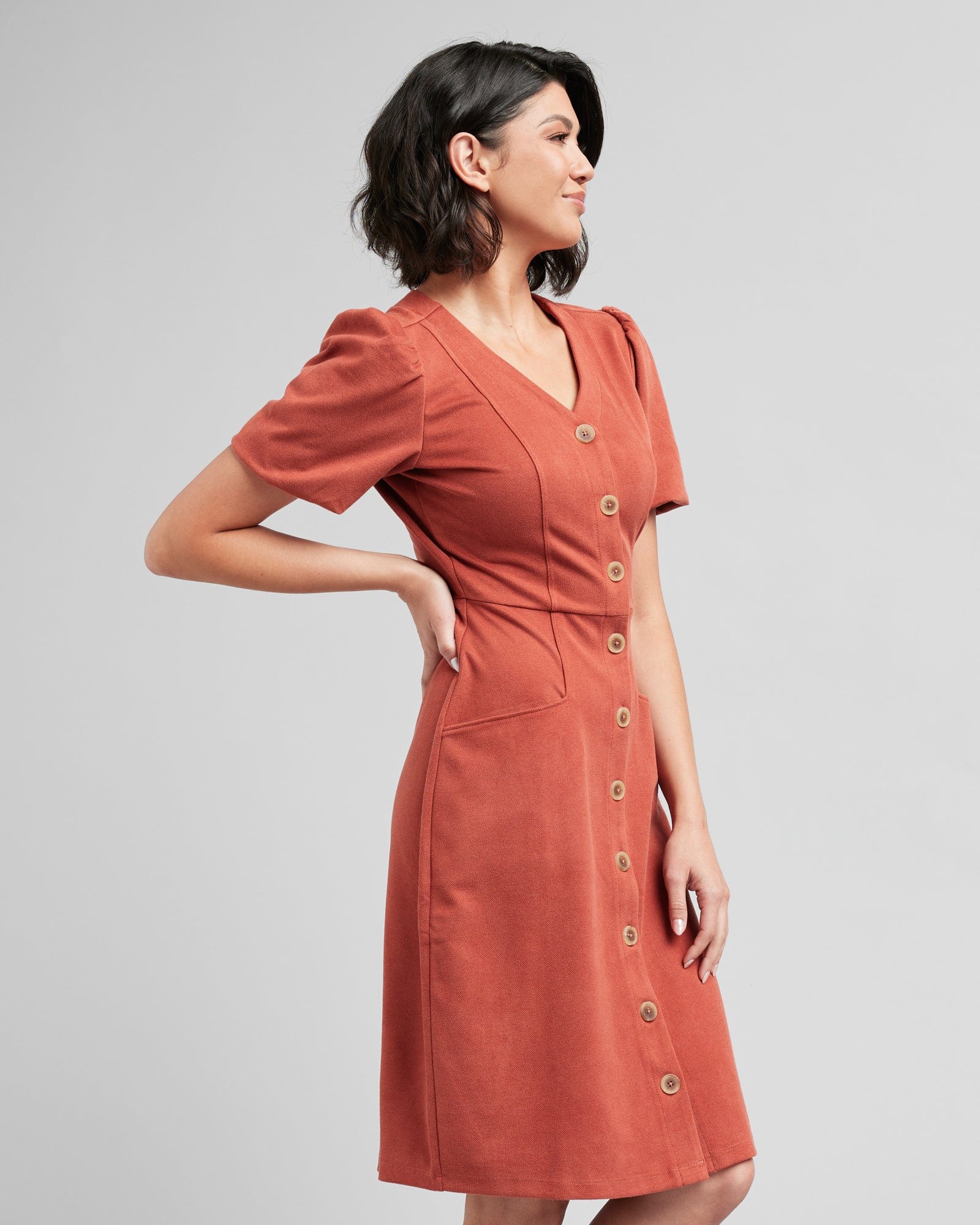 Woman in a short sleeve, v-neck, button-down, orange dress