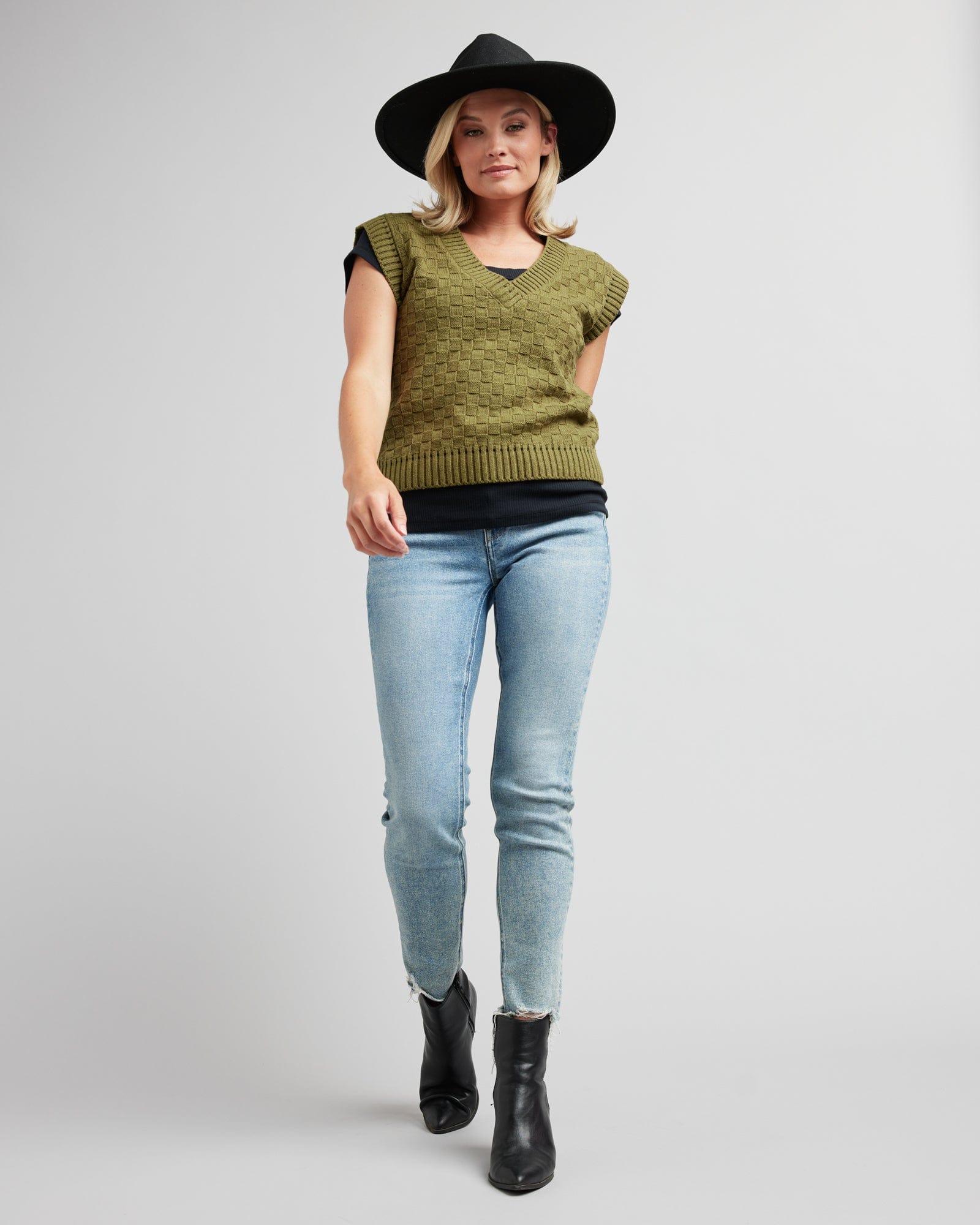 Woman in a textured knit pullover vest
