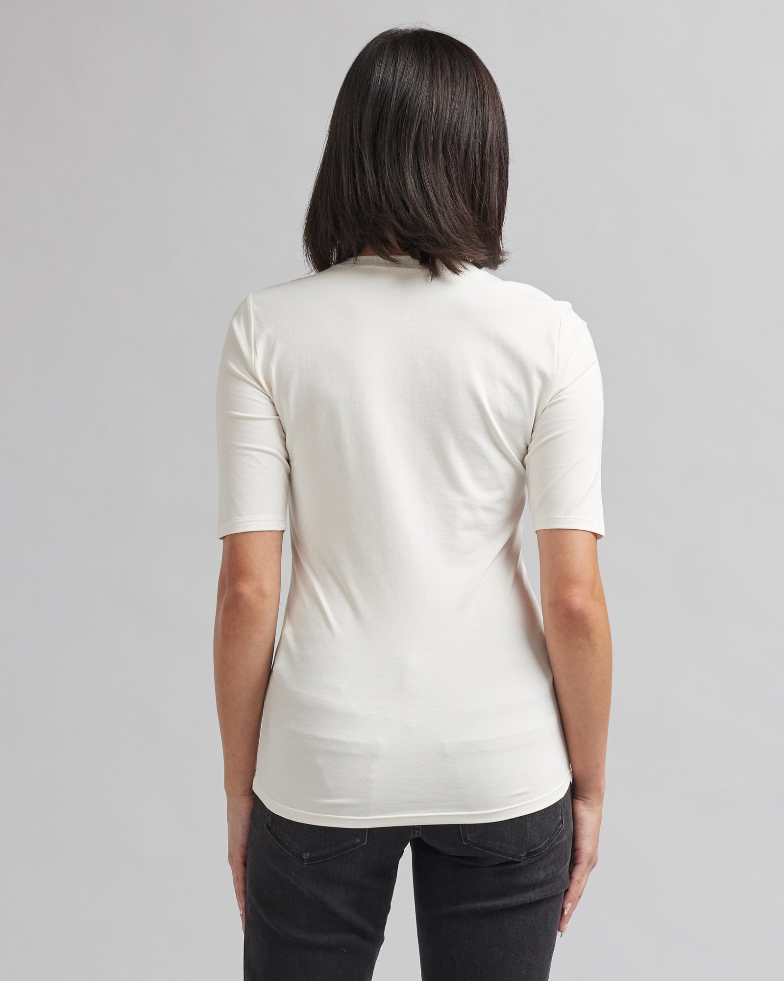 Woman in a half sleeved, basic t-shirt