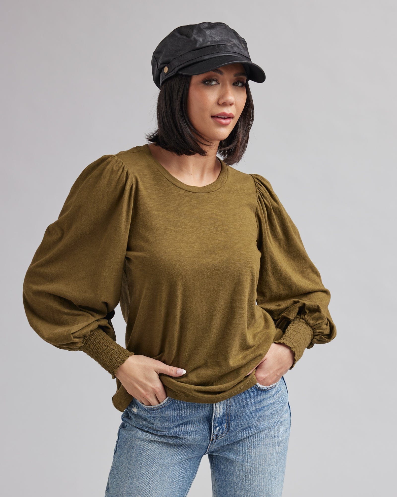 Woman in a long sleeved, balloon sleeved, t-shirt