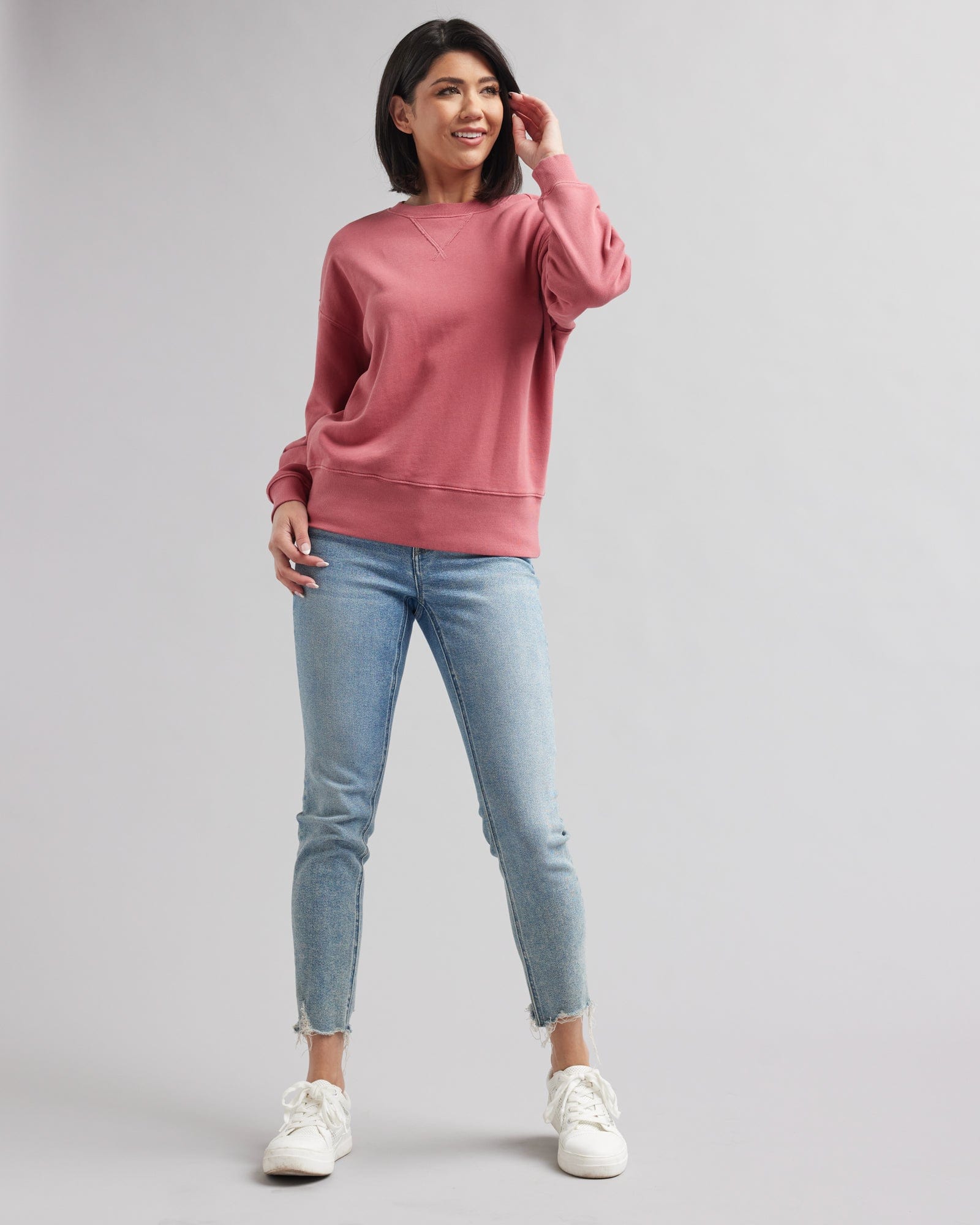 Woman in a pink, long sleeved sweatshirt