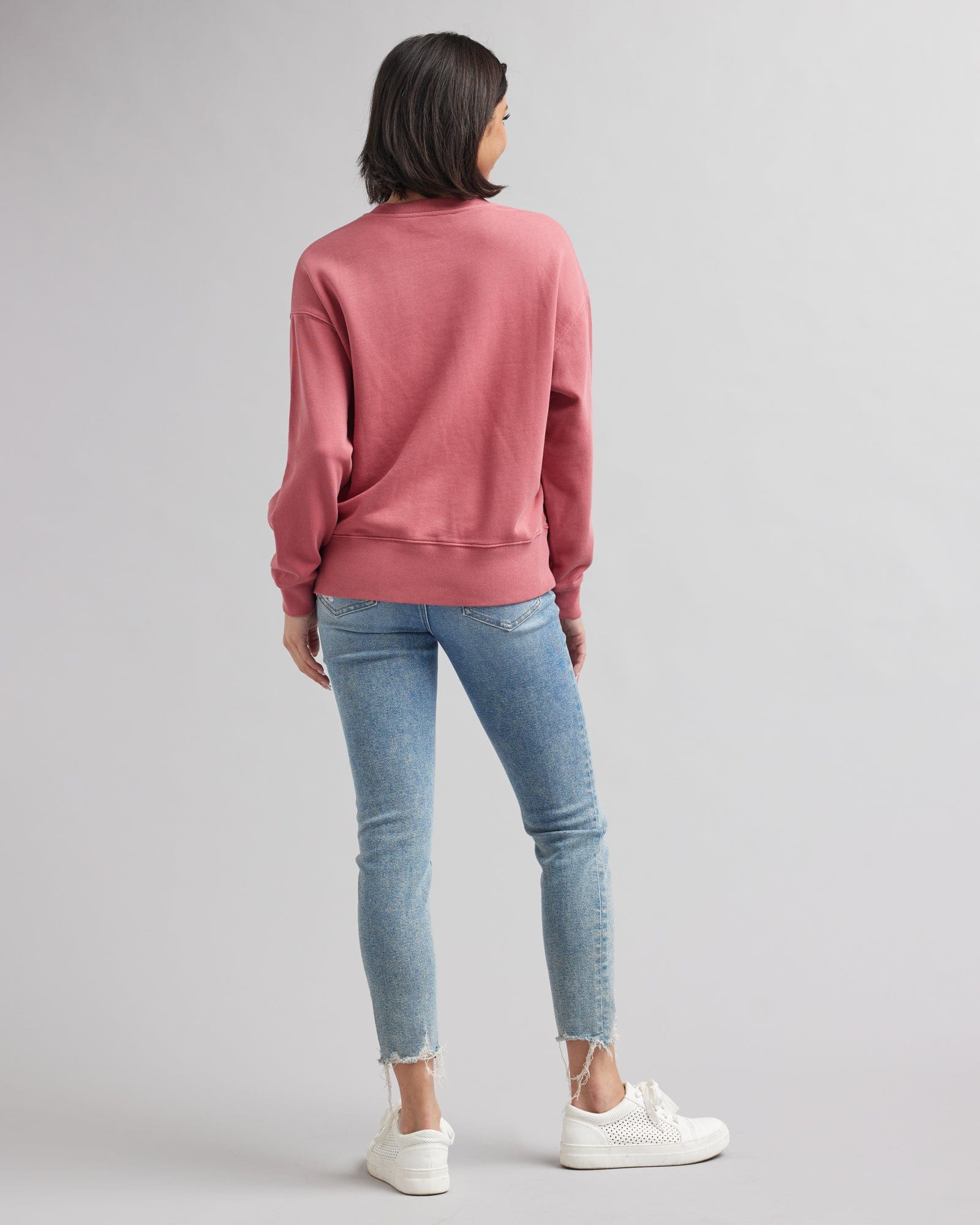 Woman in a pink, long sleeved sweatshirt
