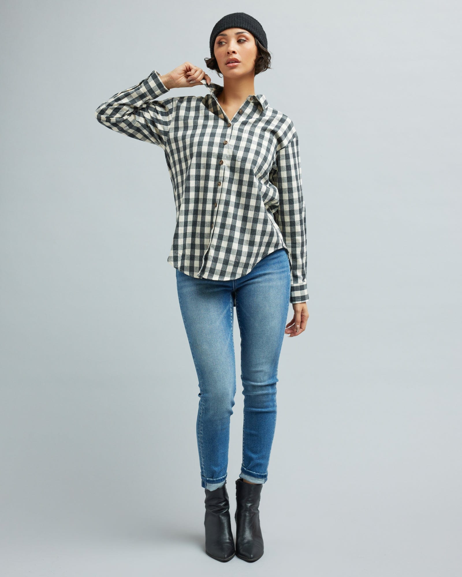 Woman in a long sleeve, black and white gingham, button-down blouse