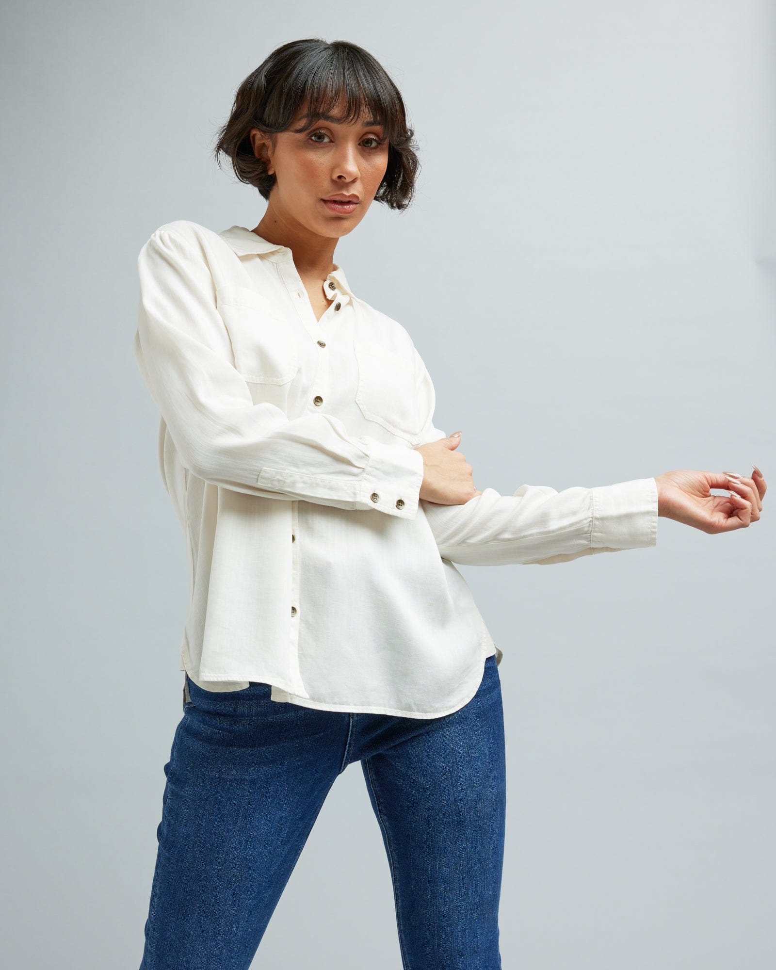 Woman in a long sleeve, white, button-down blouse