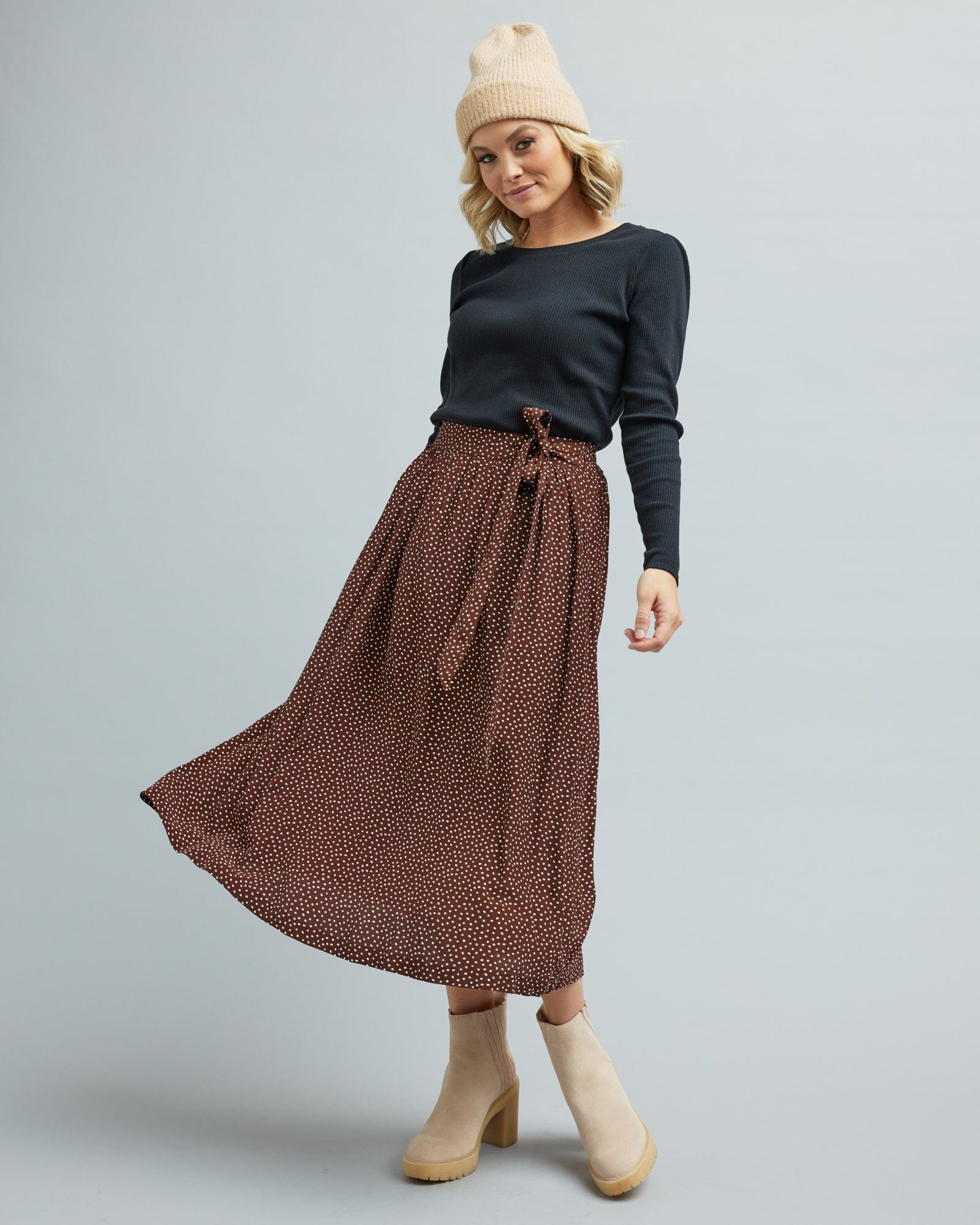 Woman in a brown, midi length skirt