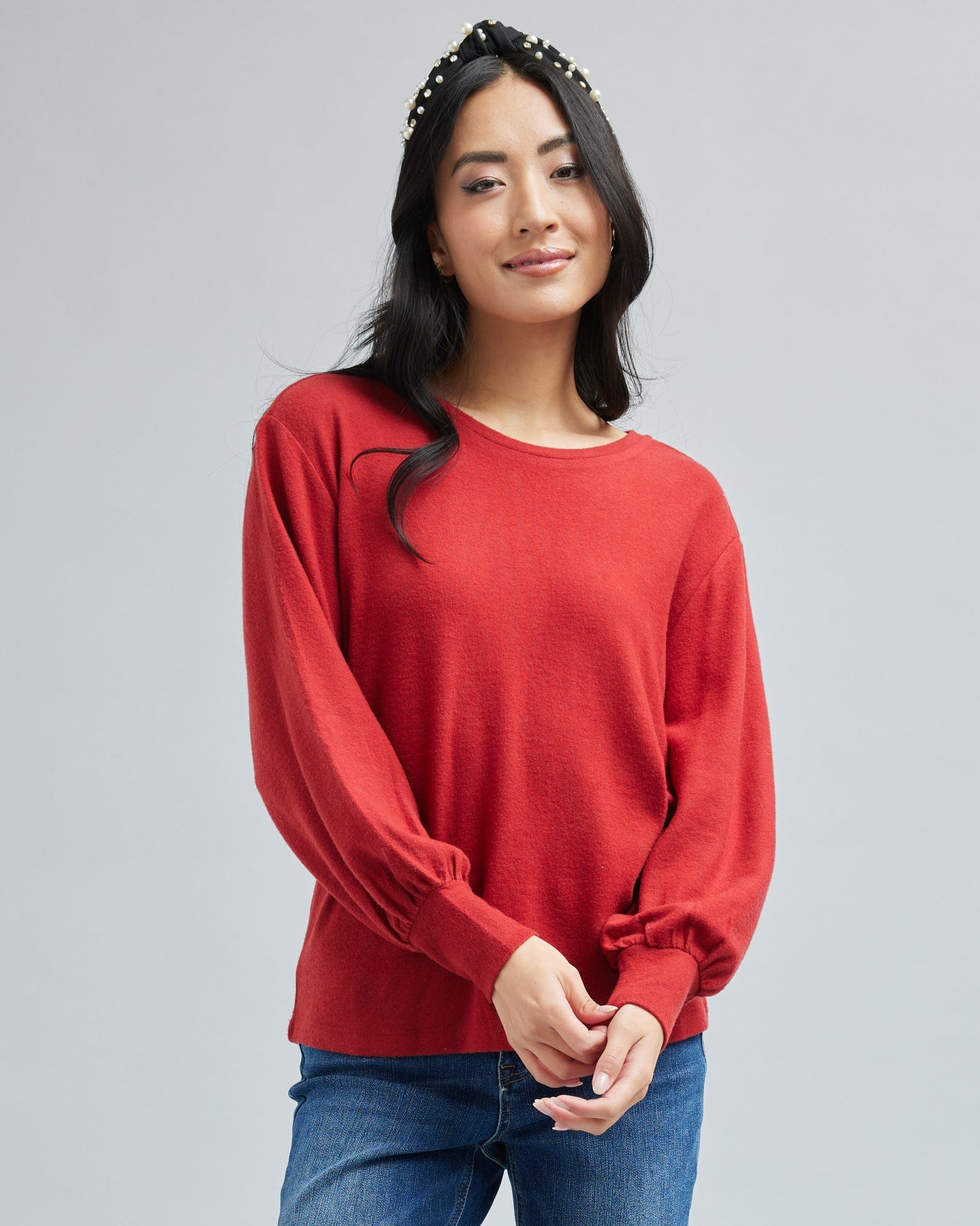 Woman in a long sleeve, red top