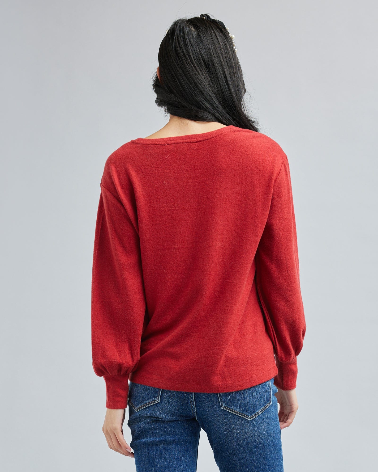 Woman in a long sleeve, red top