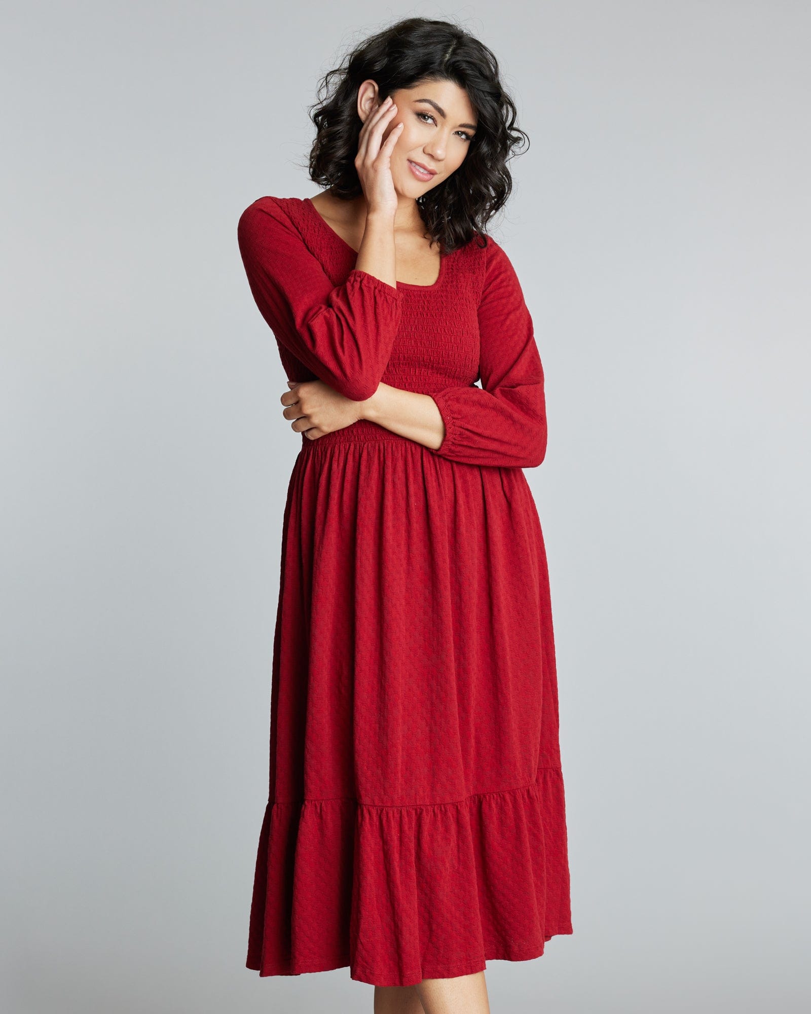 Woman in a 3/4 sleeve, red, midi-length dress