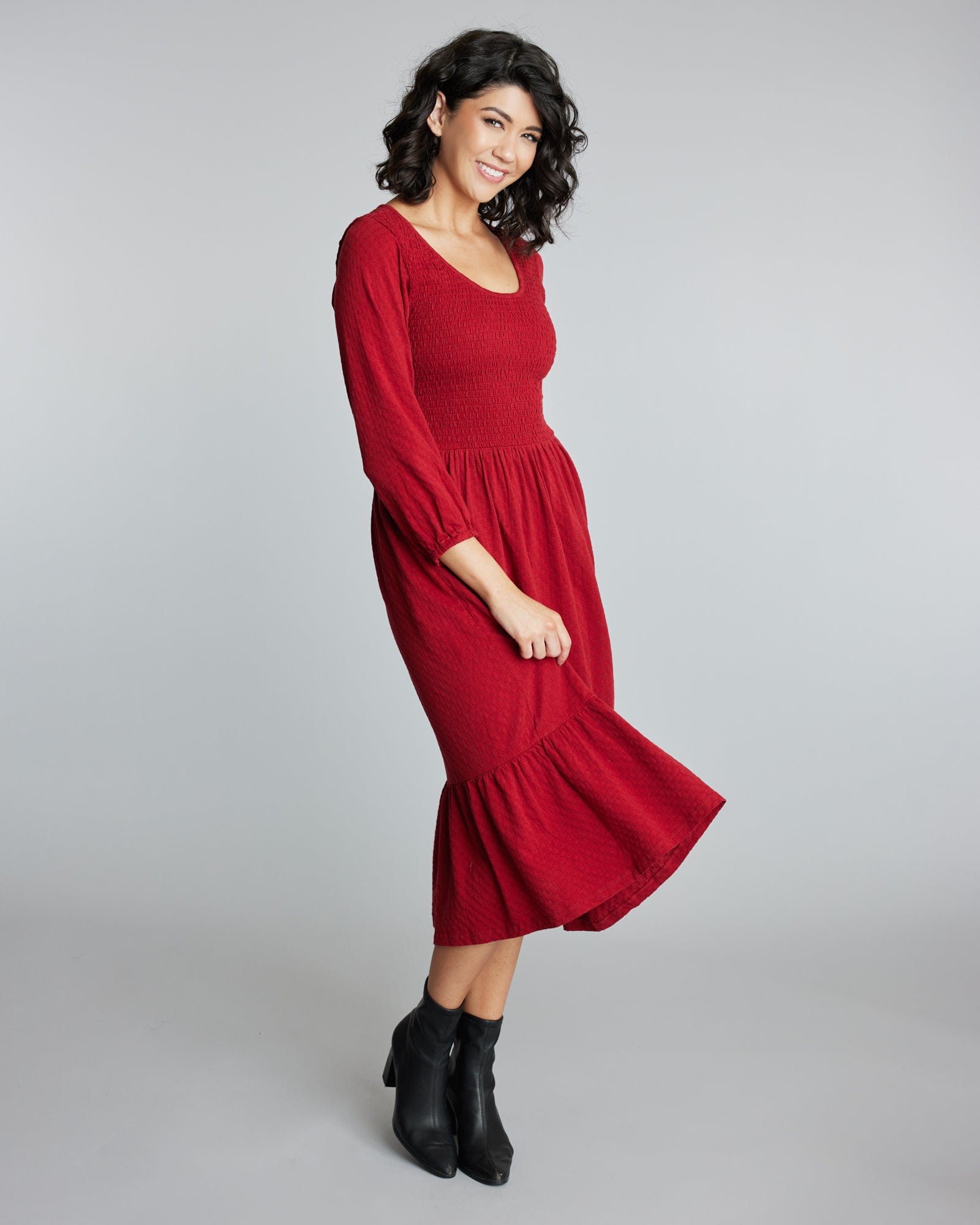 Woman in a 3/4 sleeve, red, midi-length dress