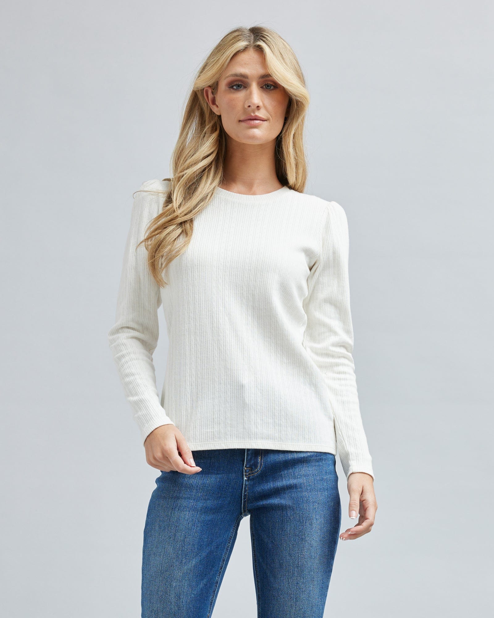 Woman in a long sleeve, ribbed, white t-shirt