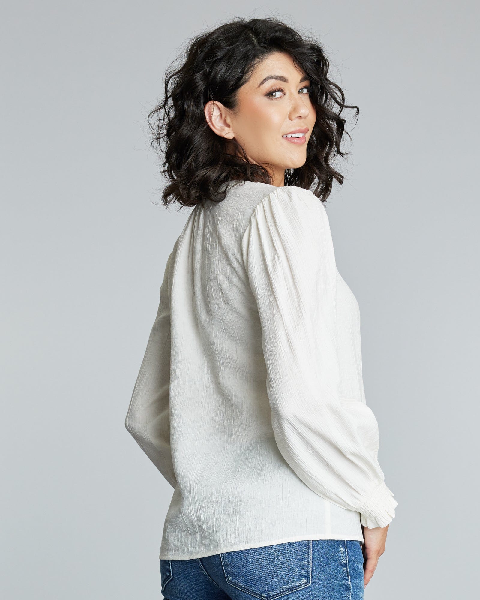 Woman in a long sleeve, white blouse