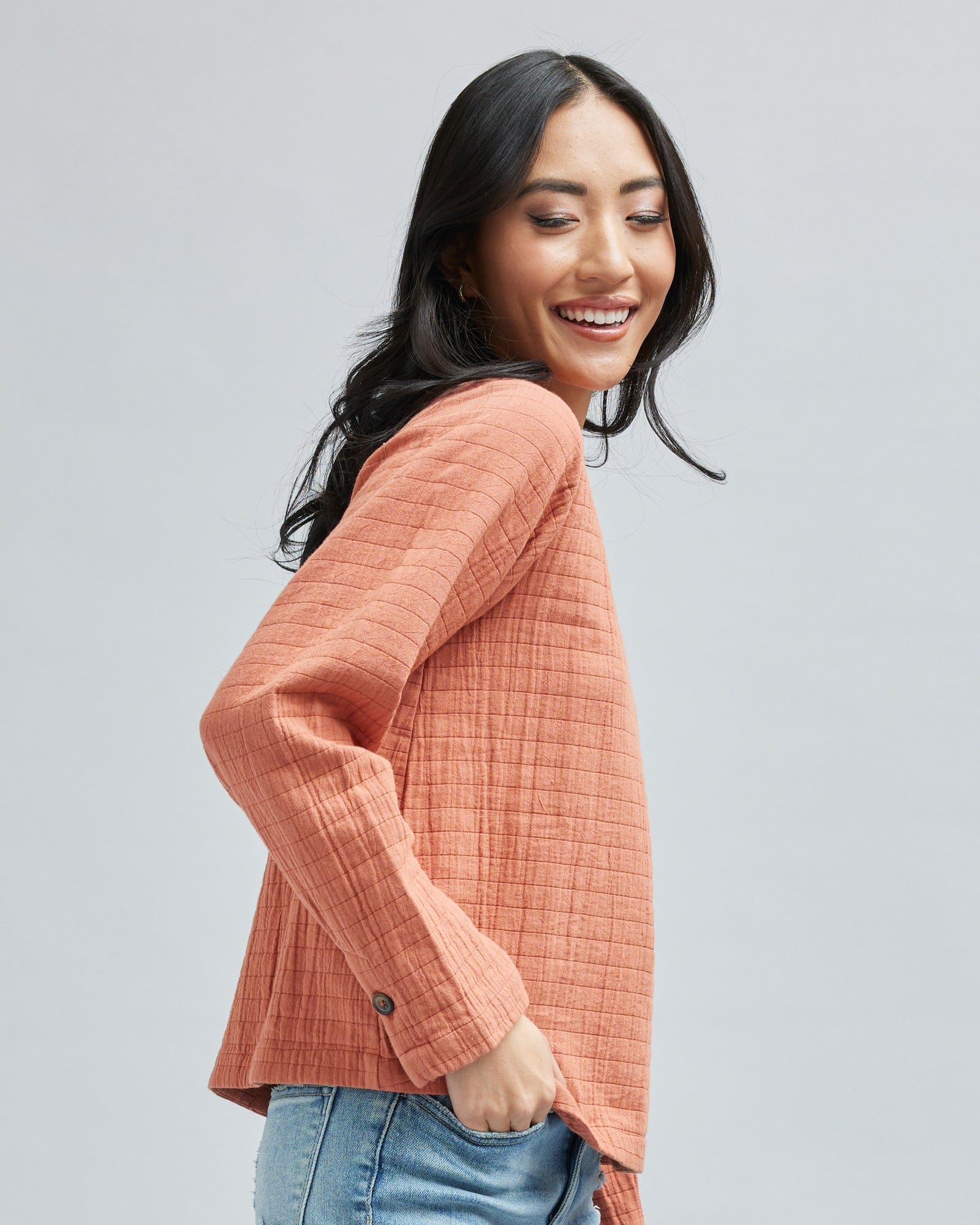 Woman in a long sleeve, orange top