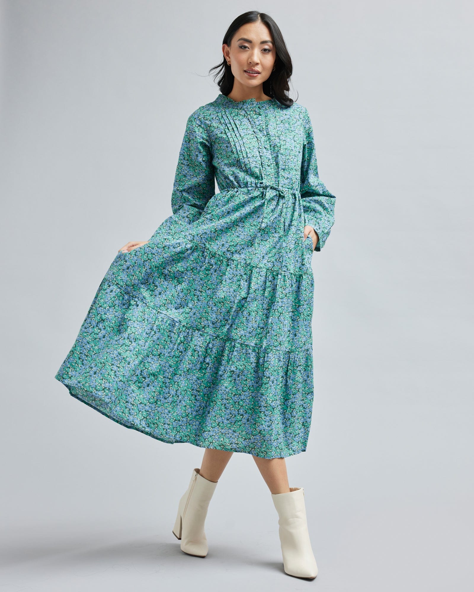 Woman in a long sleeve, teal dress