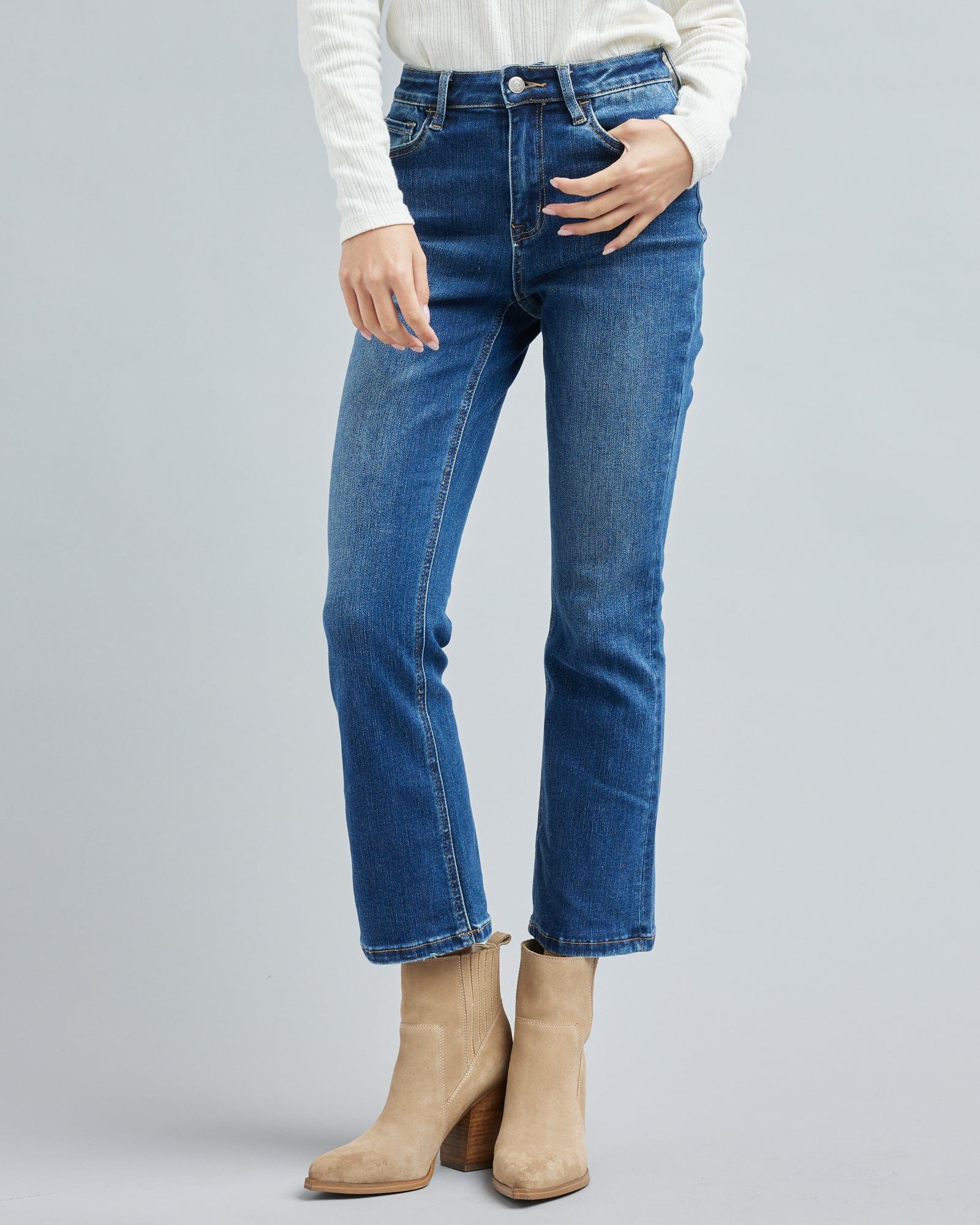 Woman in blue jean, ankle length denim pants.