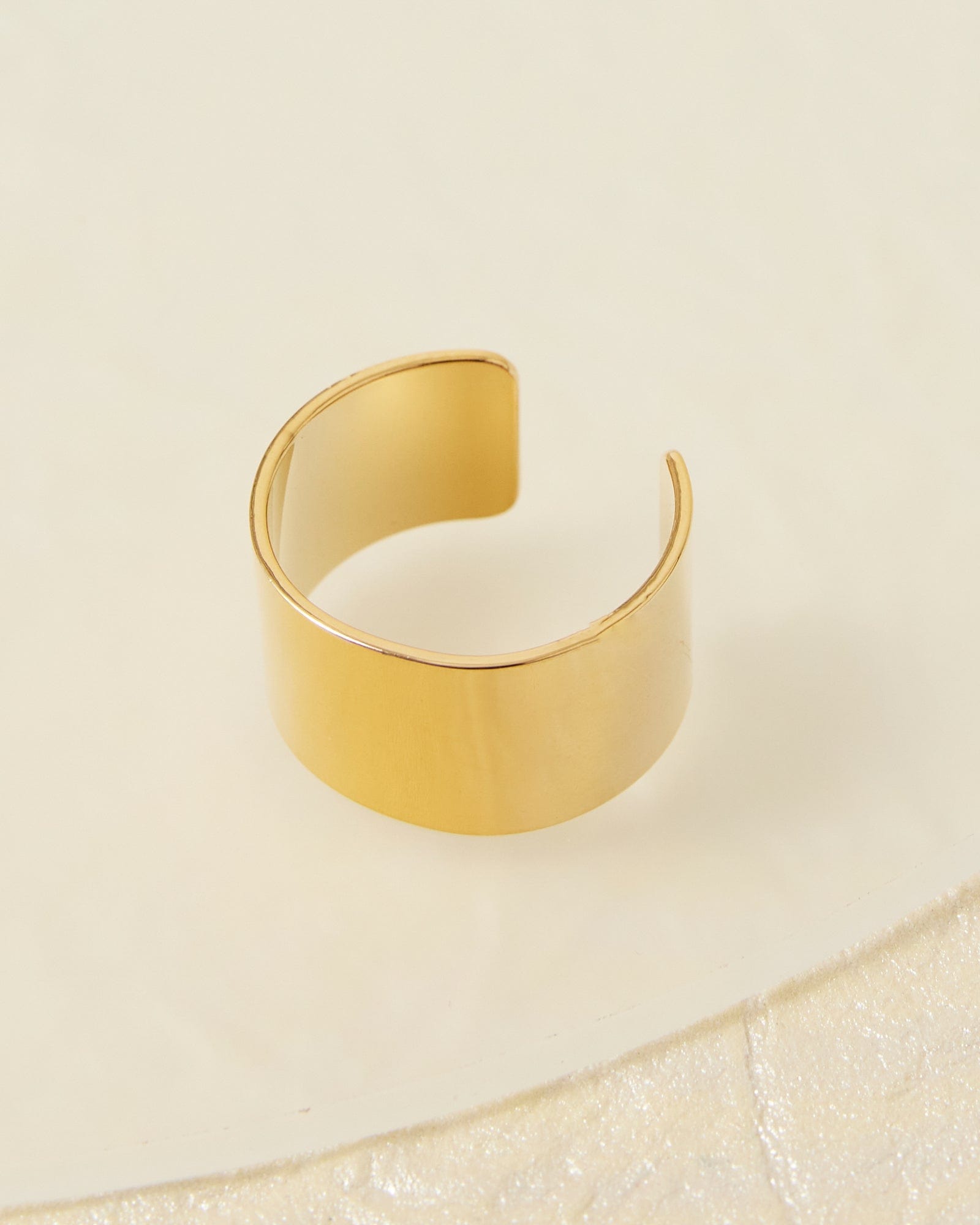 Thick gold ring resembling a cigar band.
