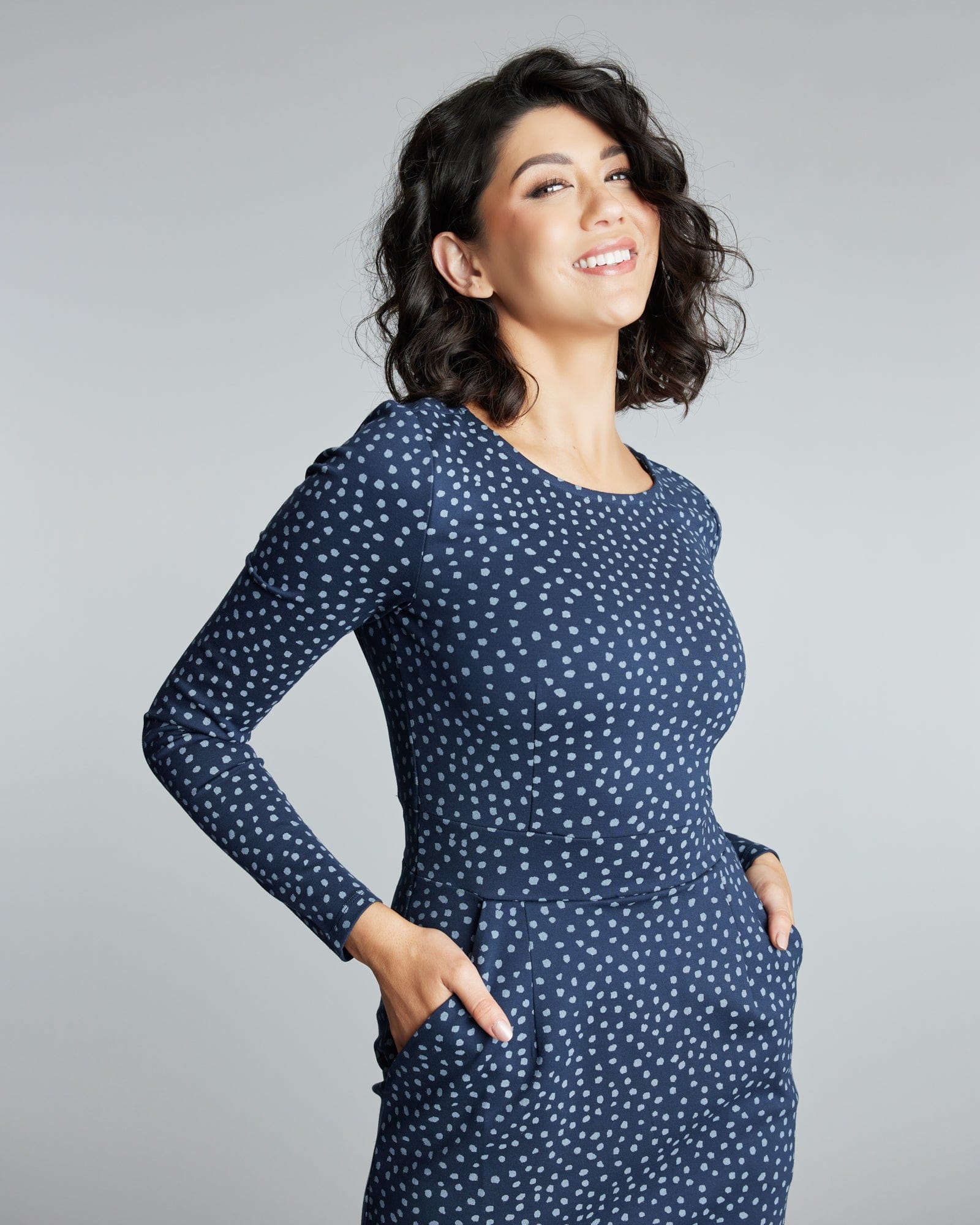 Woman in a long sleeve, knee-length polka dot dress