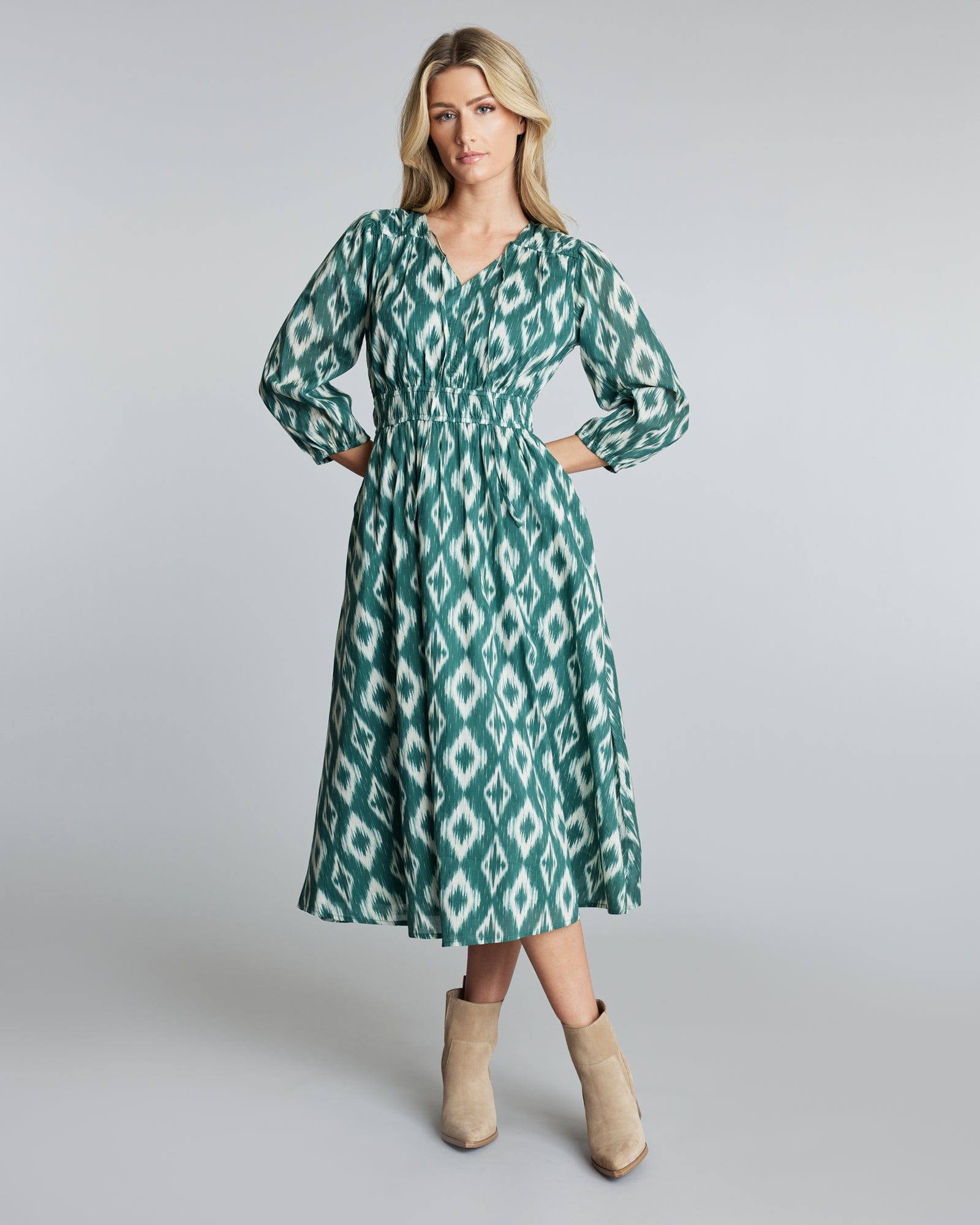 Woman wearing a green geometric print dress