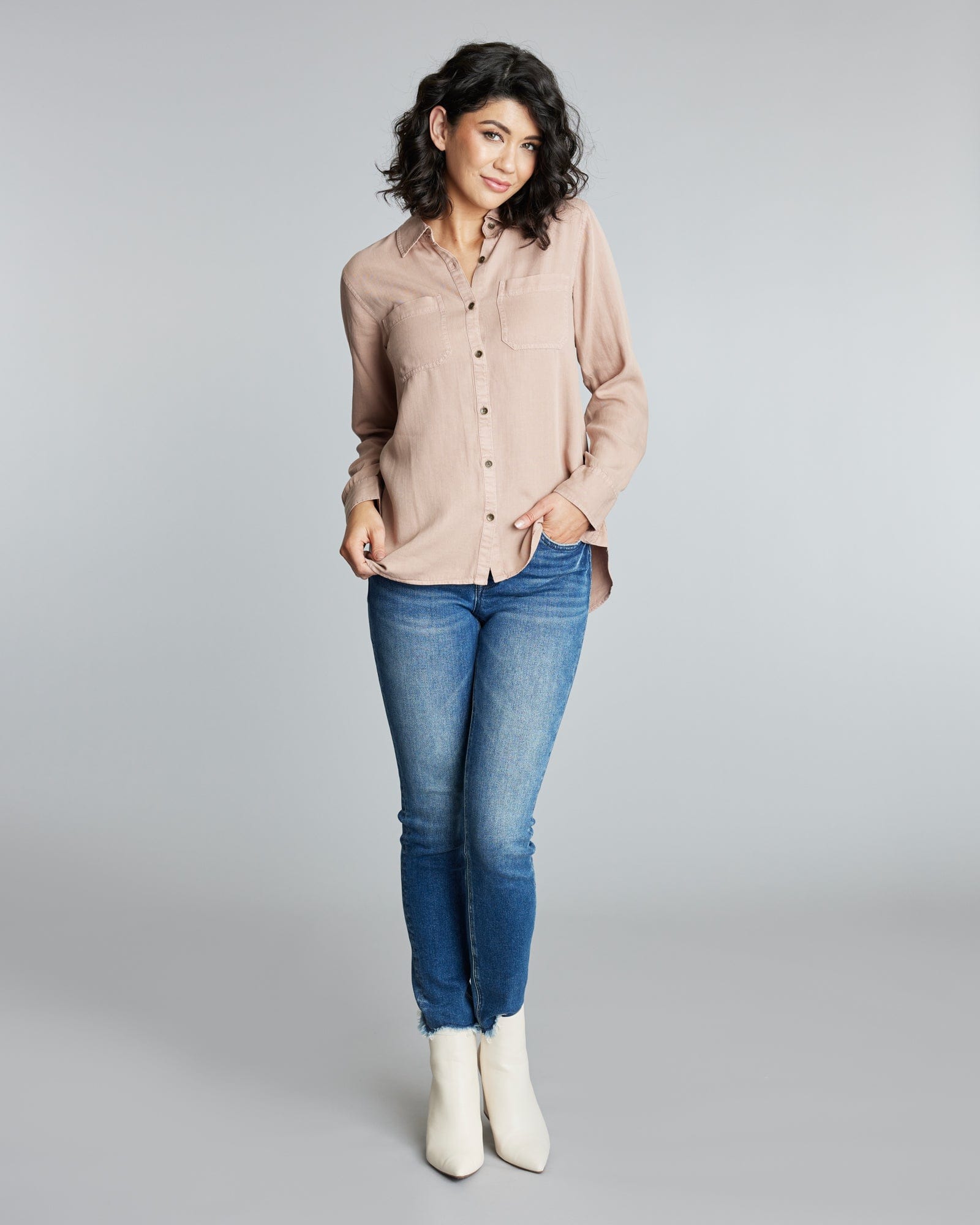 Woman in a long sleeve, pink button down blouse