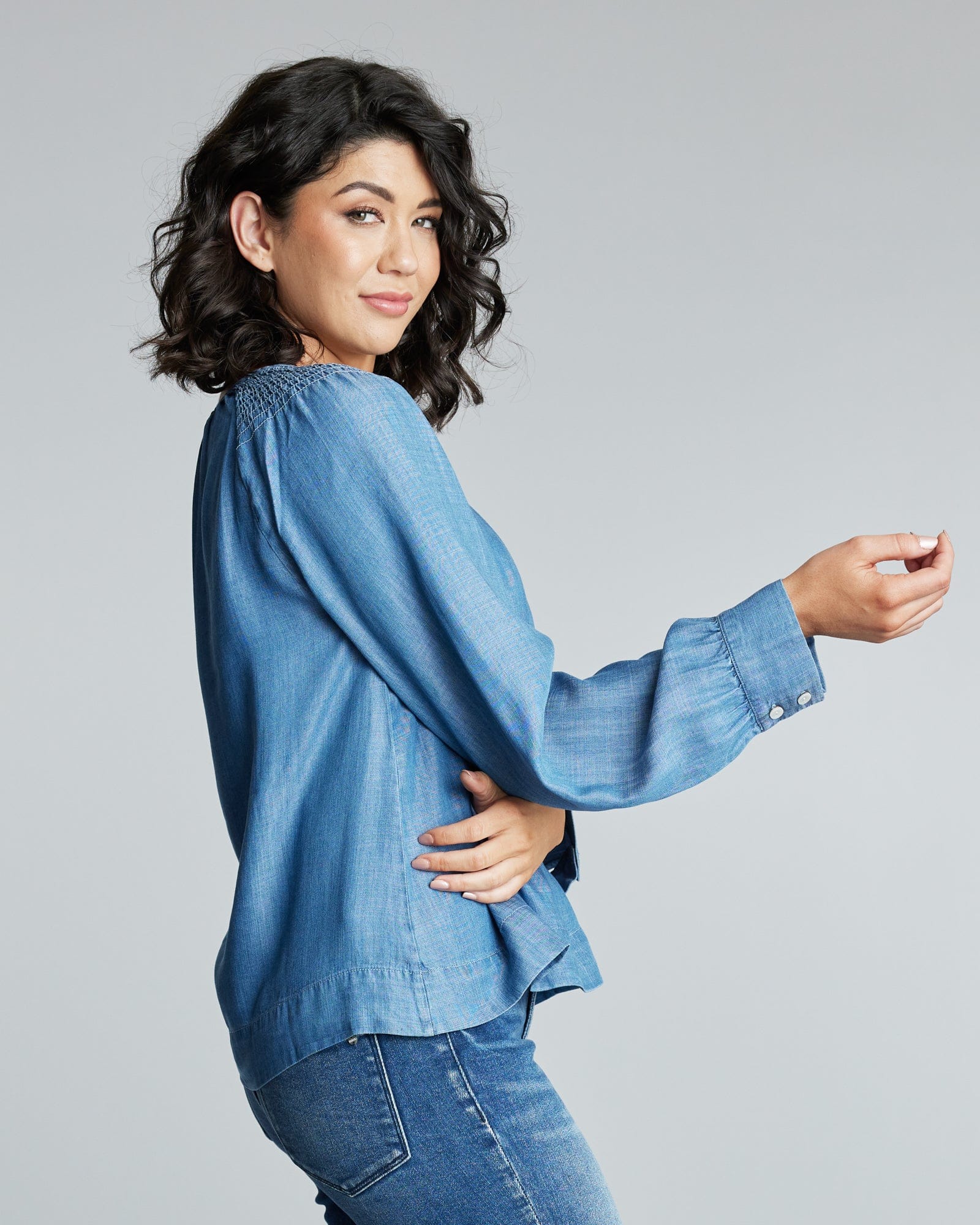 Woman in a long sleeve, denim blouse