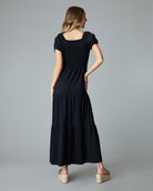Woman in a black, short sleeved, maxi dress