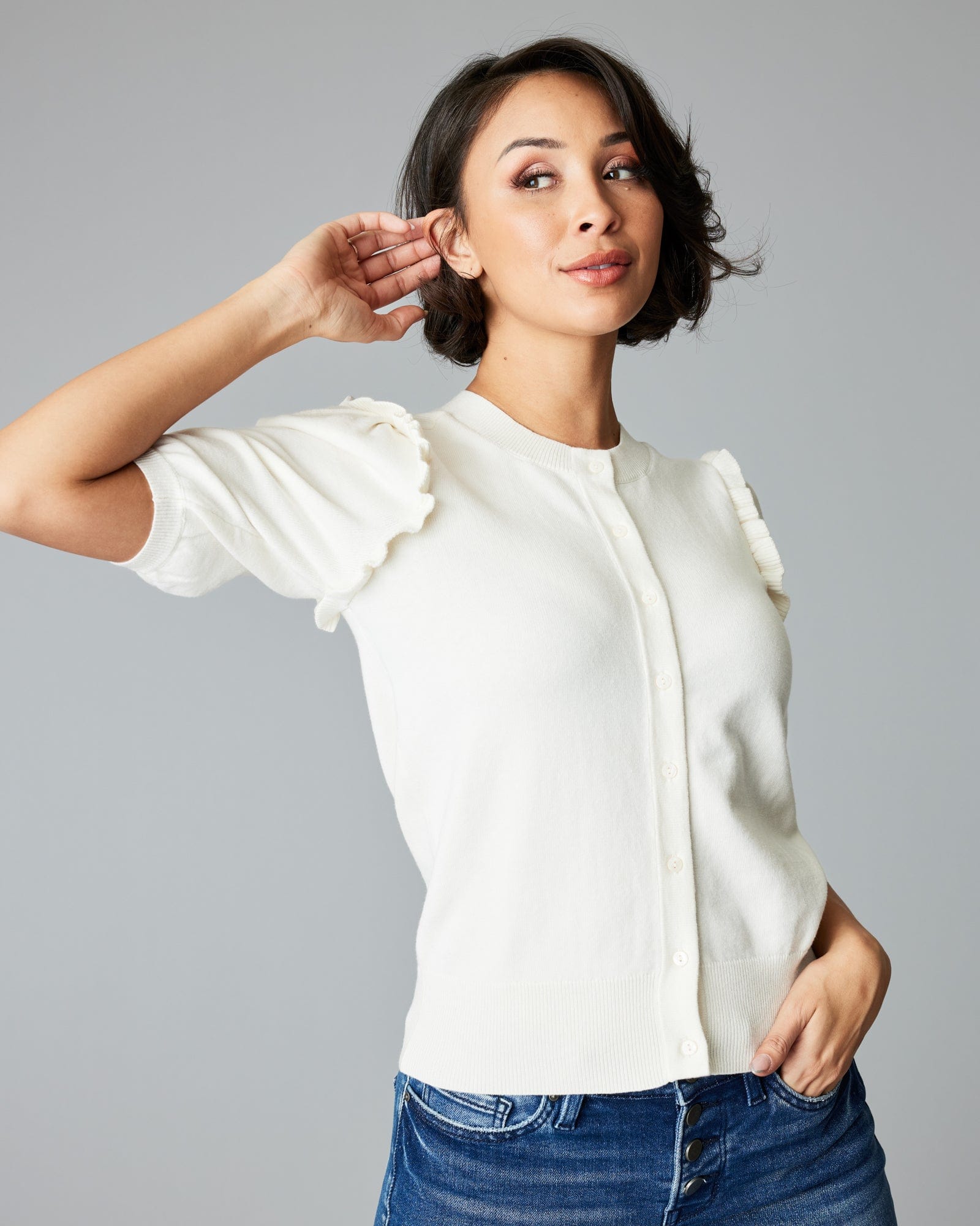 Woman in a short sleeve white cardigan.