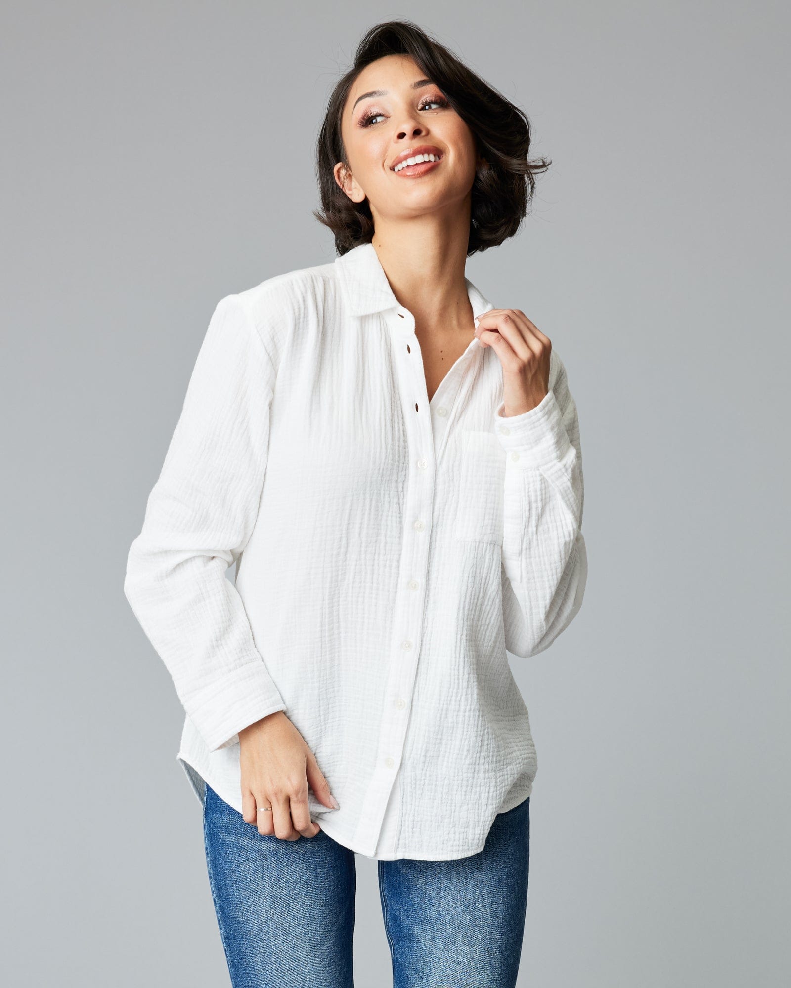 Woman in a long sleeve, white, button-down top.