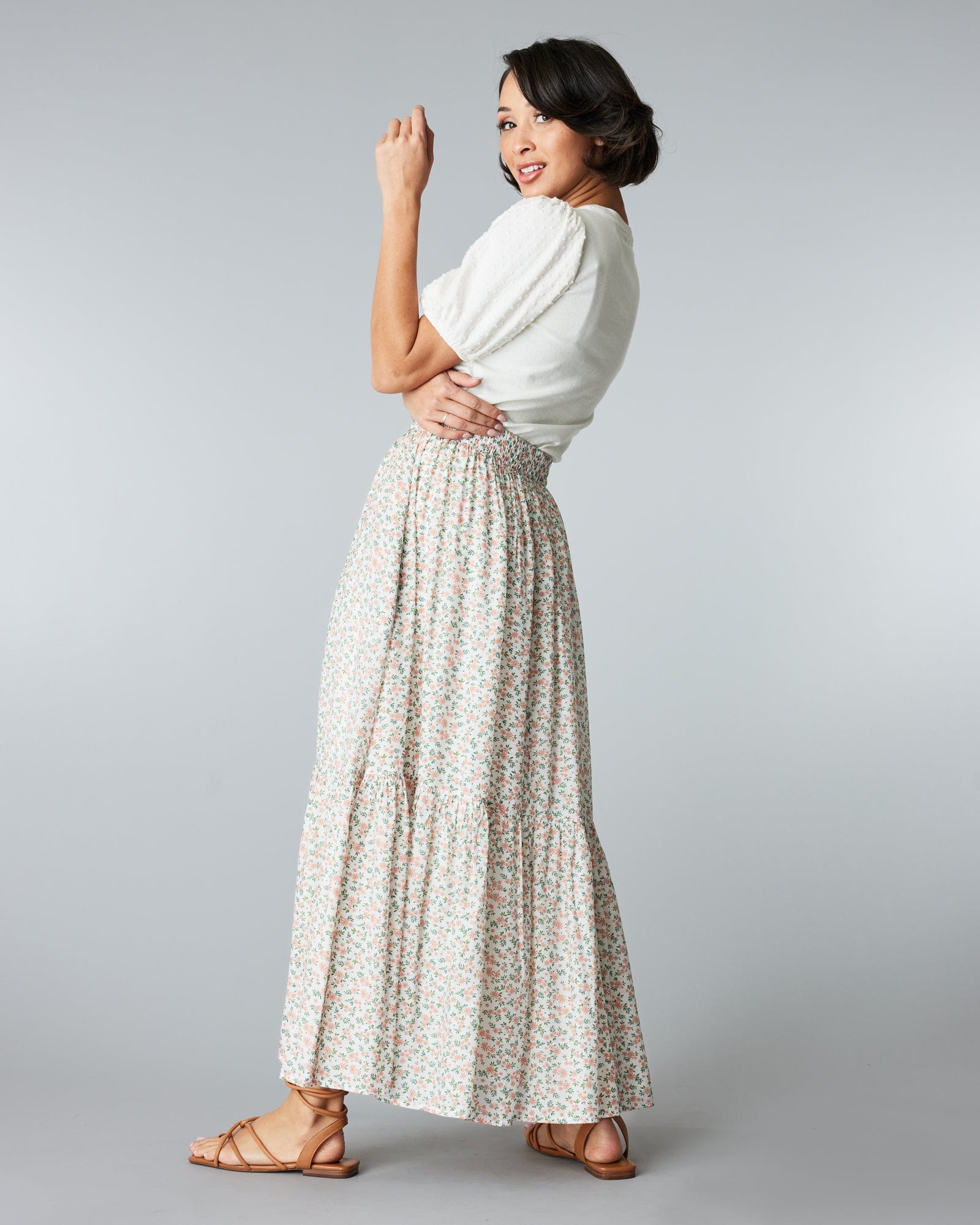 Woman in a maxi length, floral printed skirt