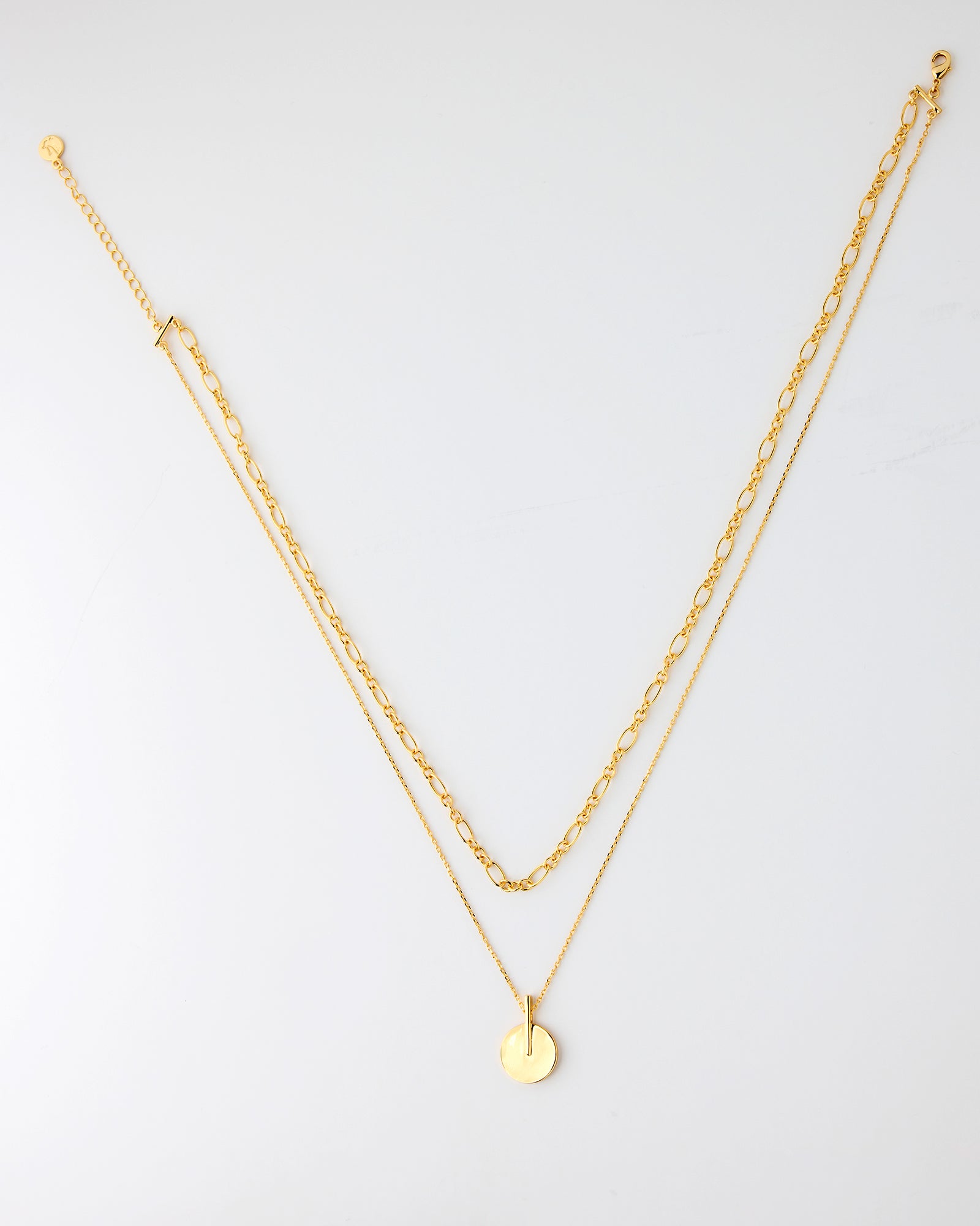 Gold chain necklaces with a circle charm on longer chain