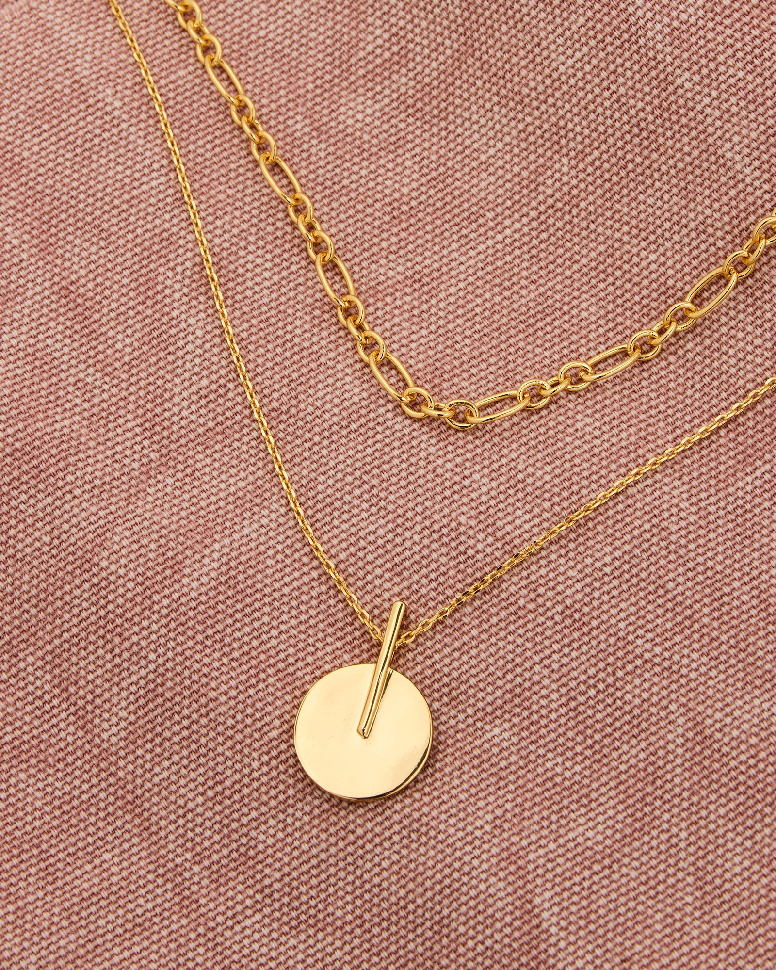 Gold chain necklaces with a circle charm on longer chain