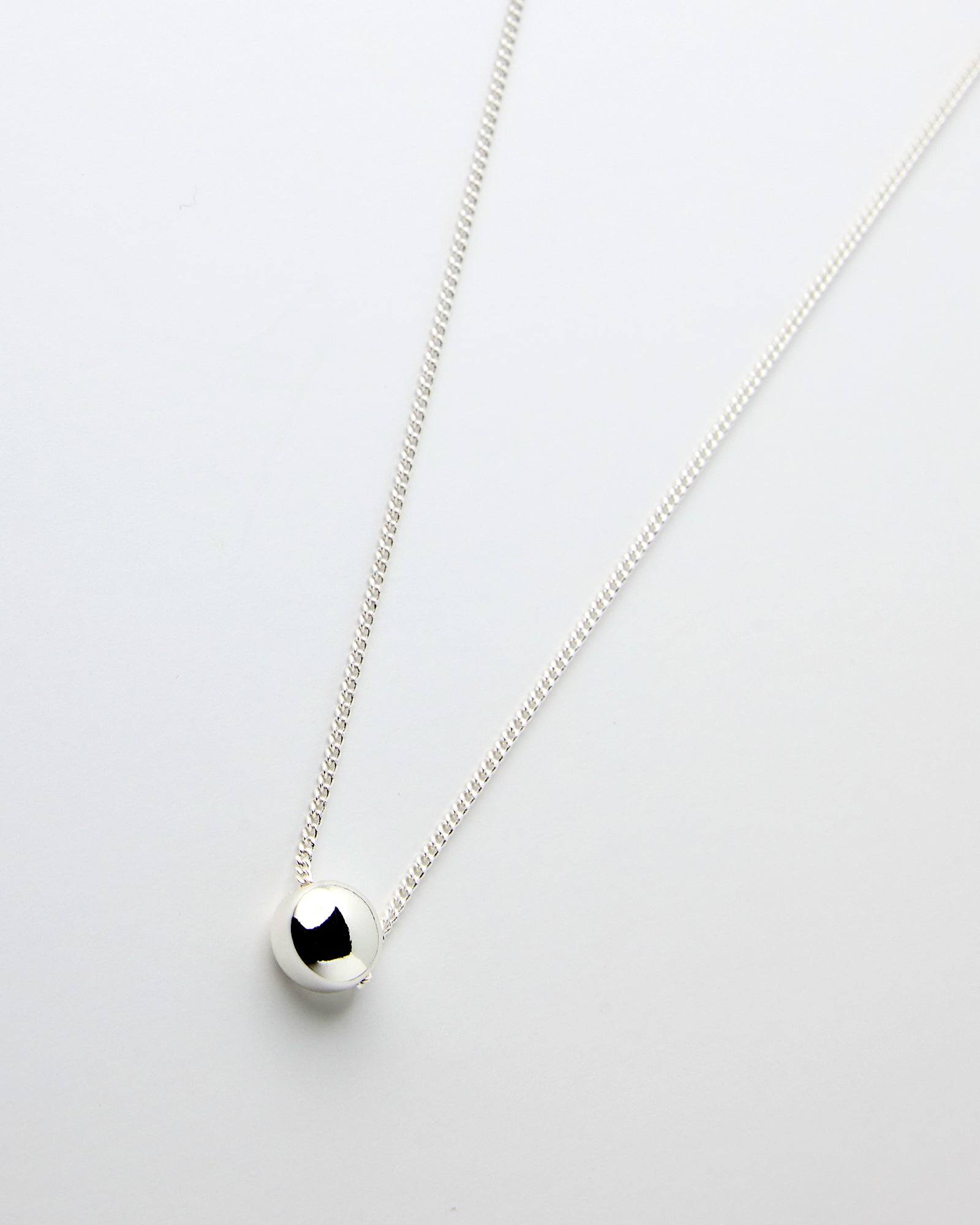 Silver chain necklace with silver bead in middle